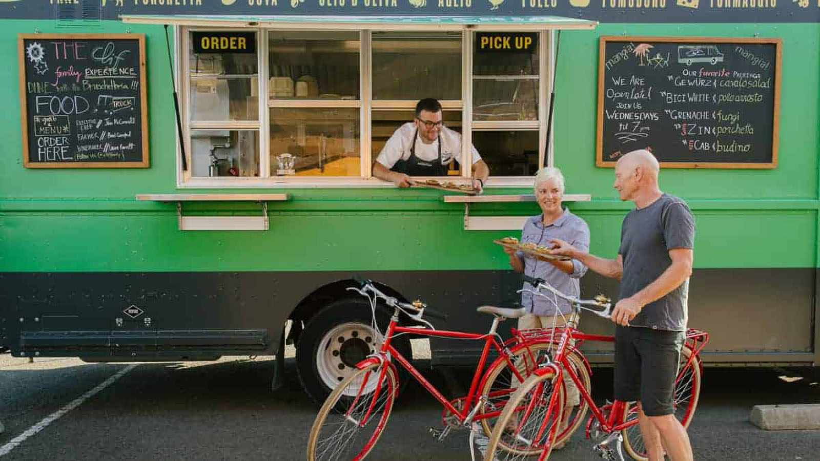 Couple at a food truck with bicycles.