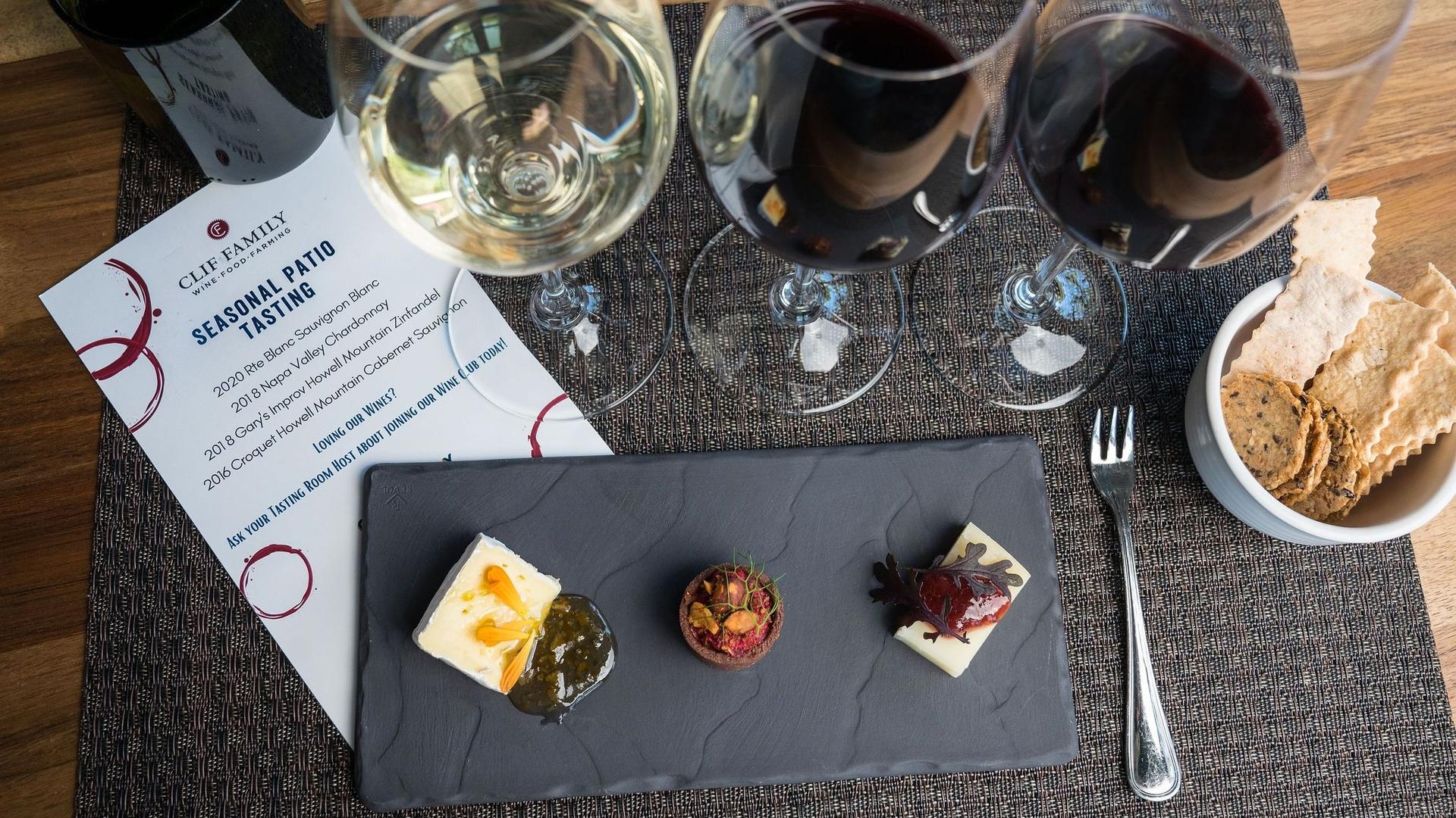 Wine tasting setup with cheese and crackers platter.