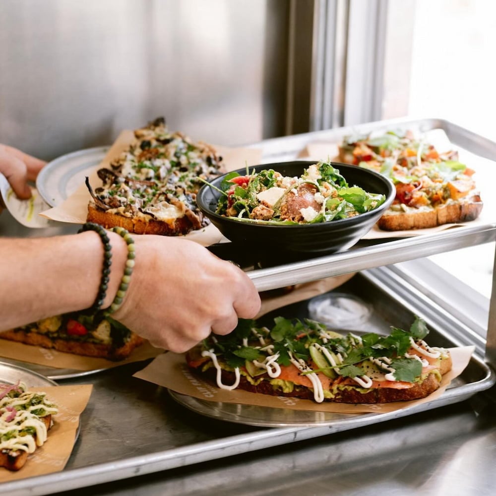 Tray of gourmet toasts and fresh salad bowl