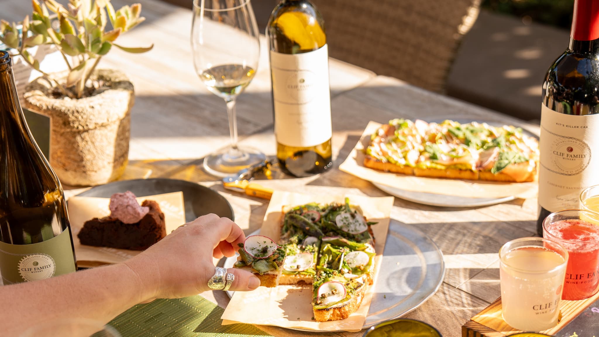 Outdoor wine and flatbread meal in sunlight