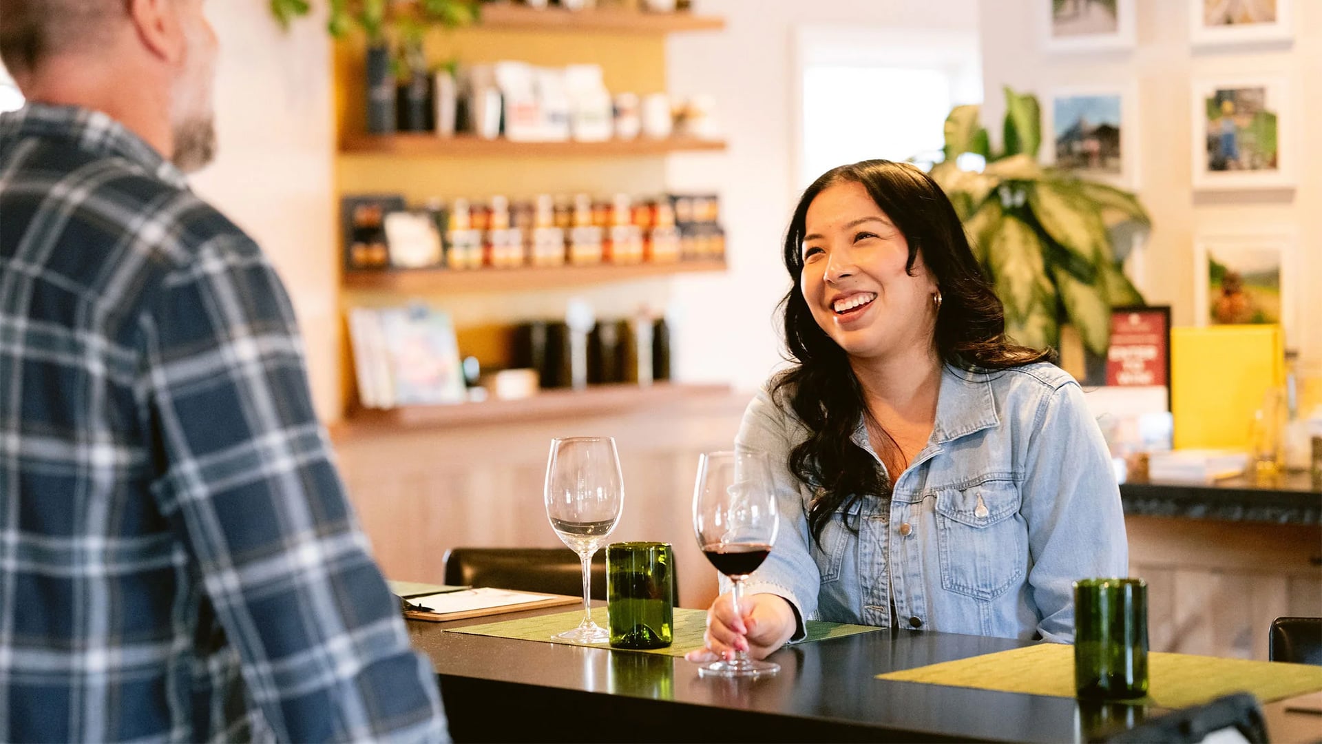 Woman smiling over wine at a restaurant table
