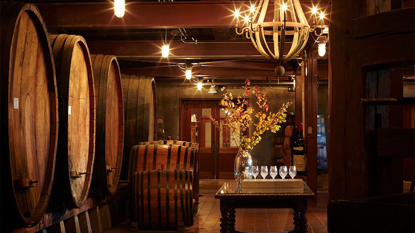 Wine barrels in a dimly lit cellar.