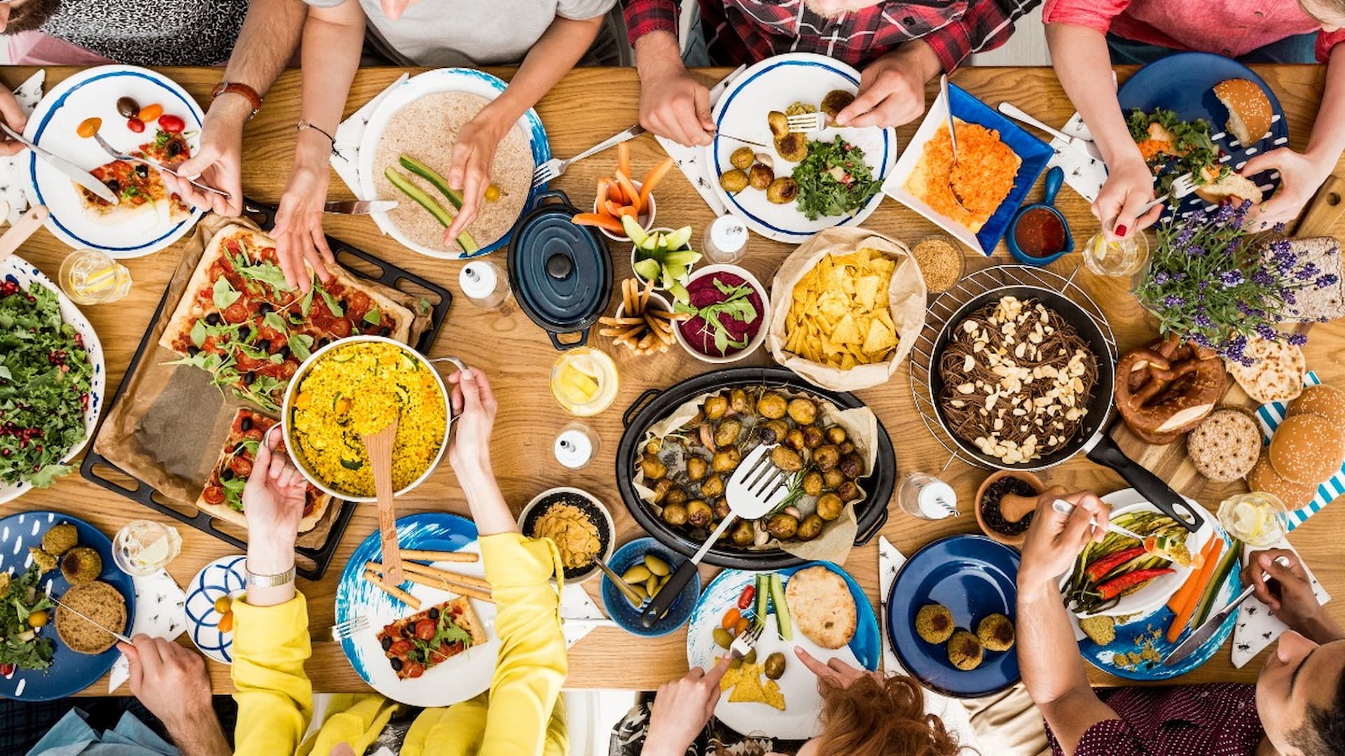 People sharing assorted dishes at a vibrant dinner table