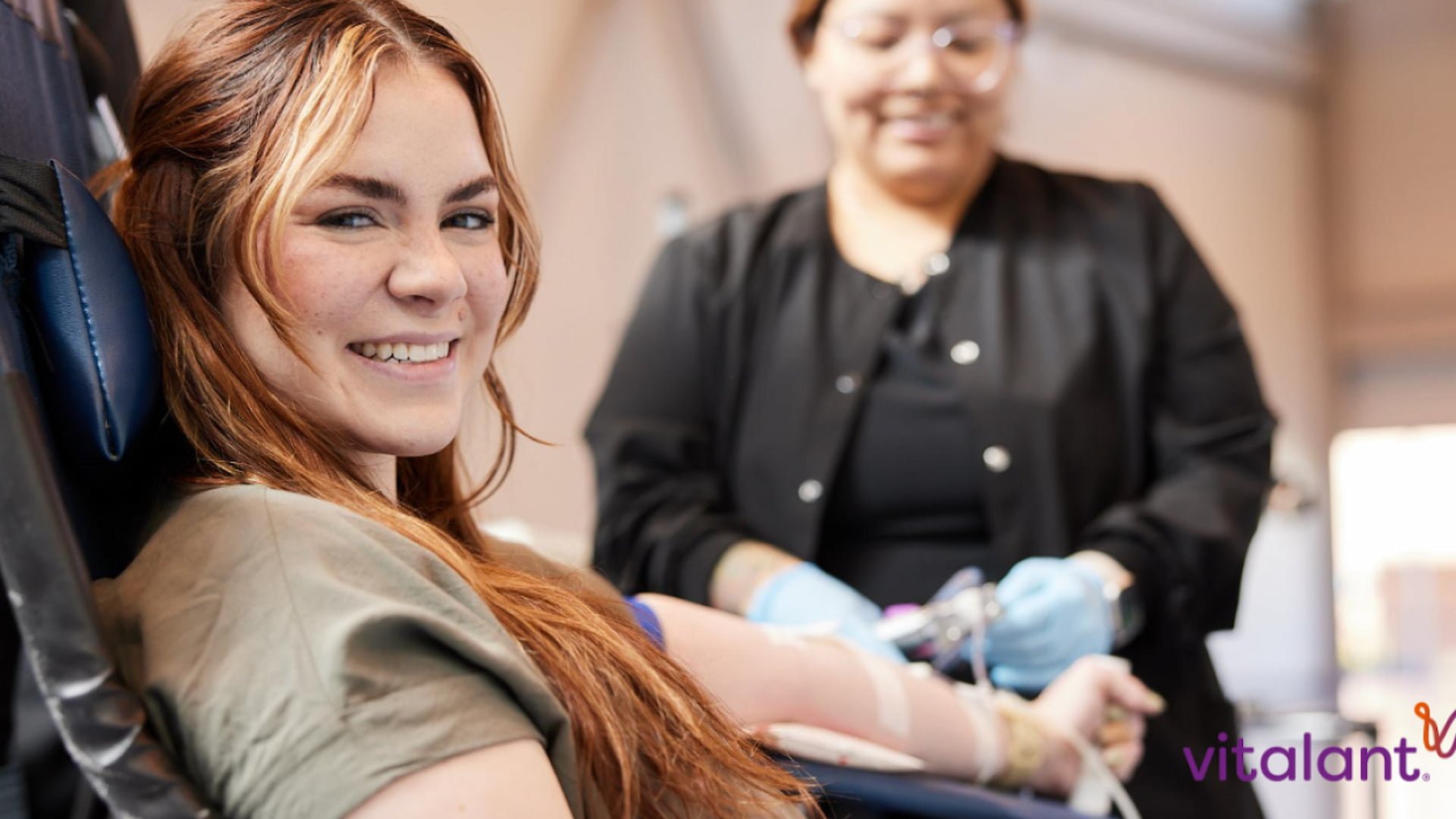 Smiling woman donating blood at a clinic