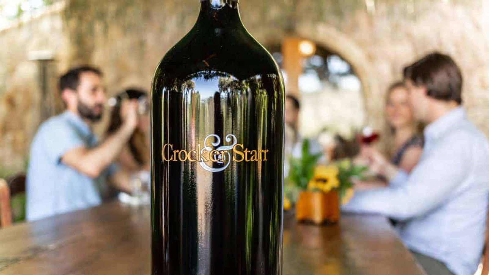 Crocker & Starr wine bottle with people in background