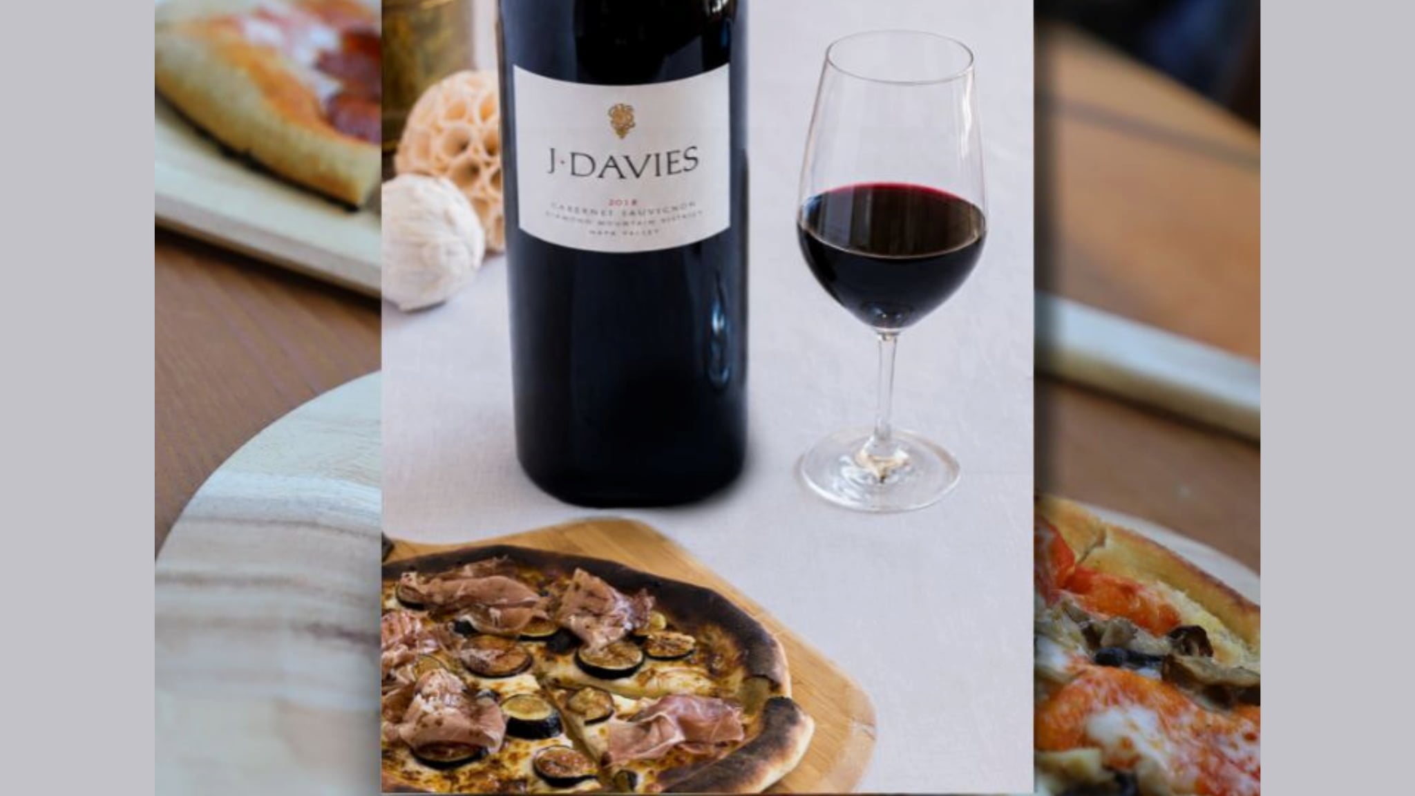 Bottle and glass of red wine with pizza