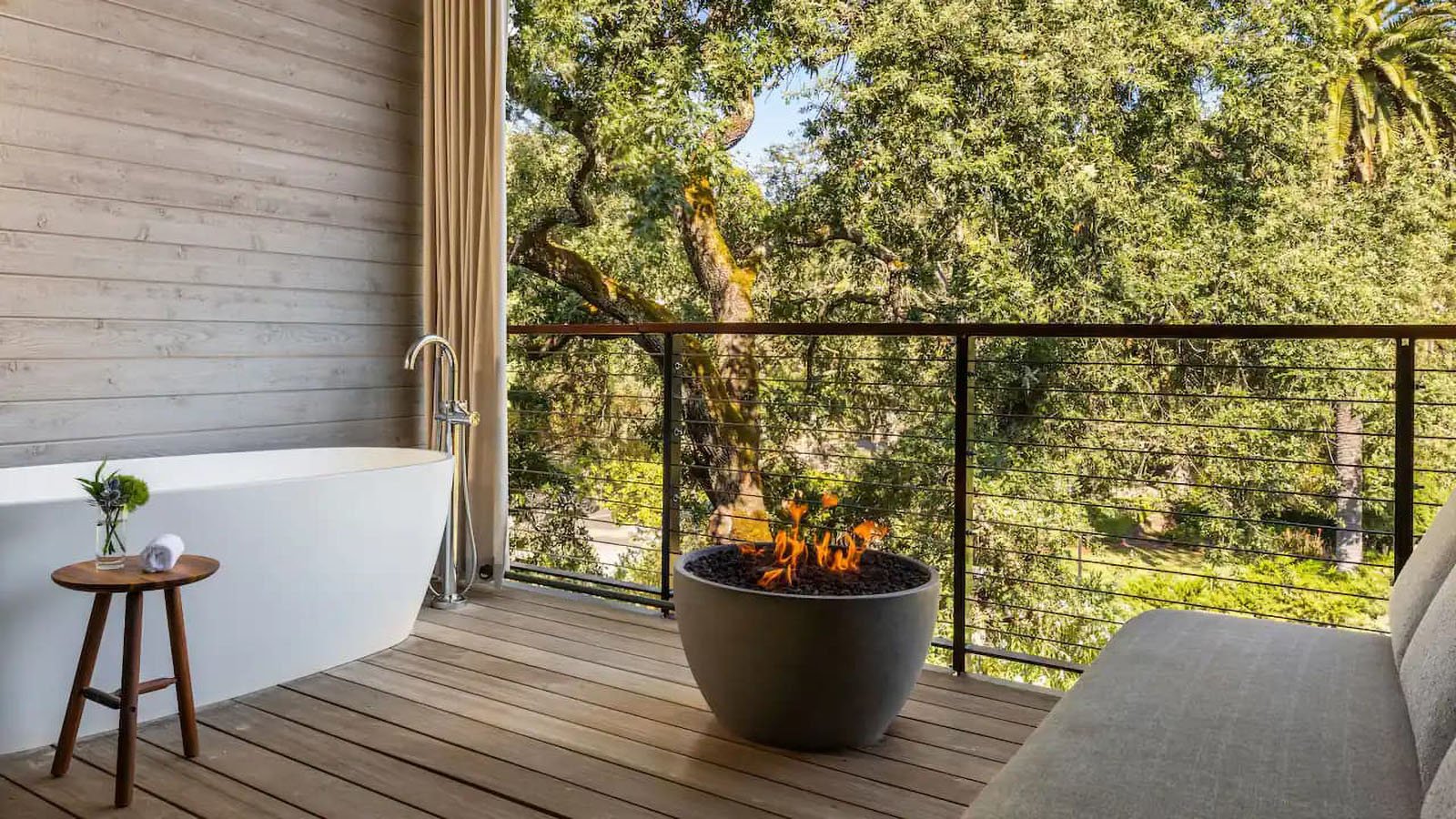 Outdoor balcony with bathtub and fire pit