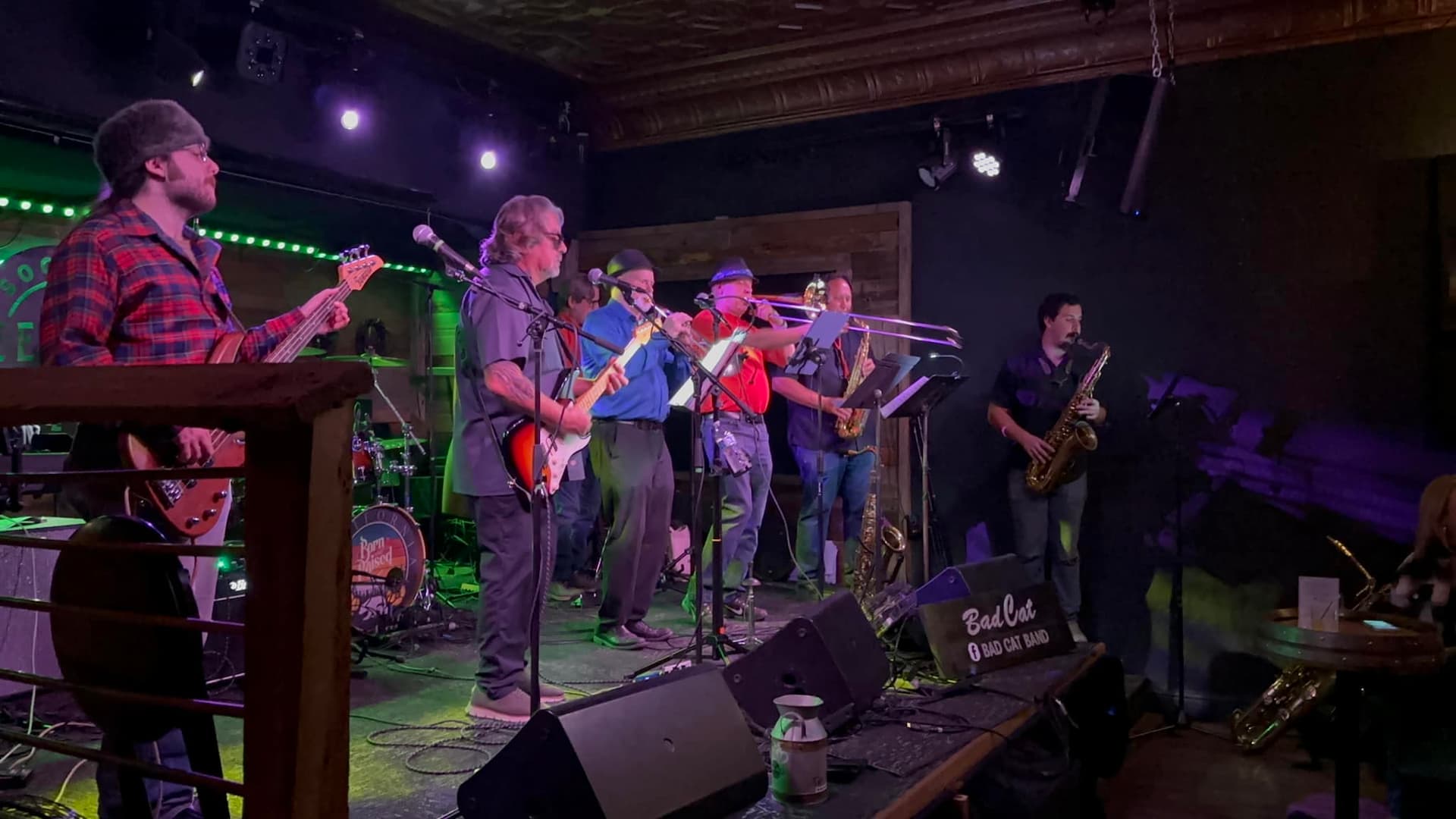 Live band performing on stage with instruments.