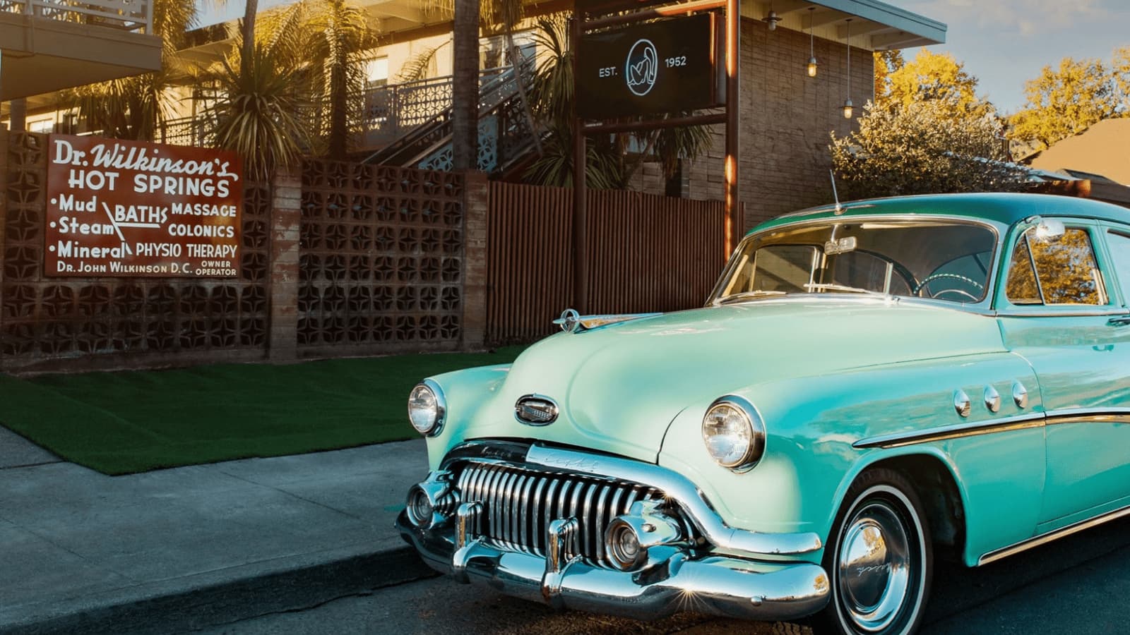 Vintage car parked at hot springs entrance