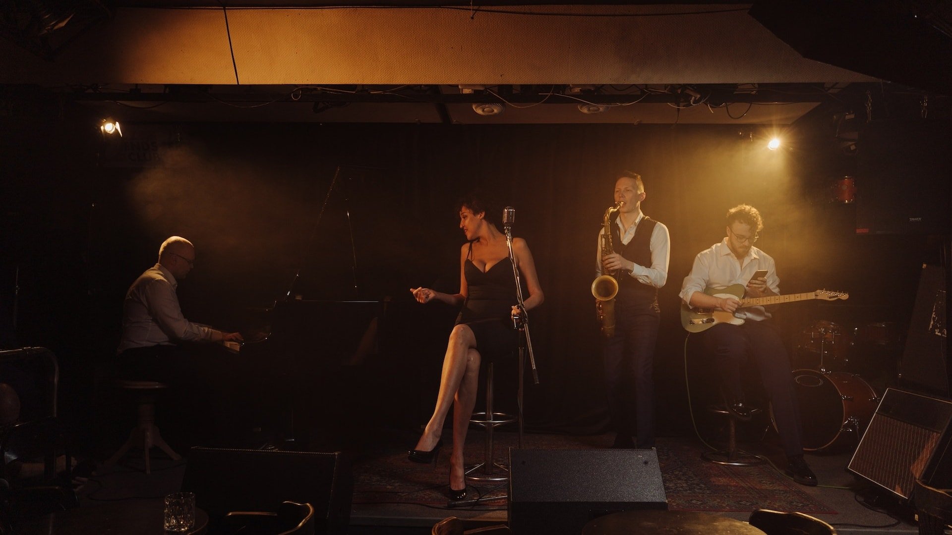 Jazz band performing on stage with instruments.