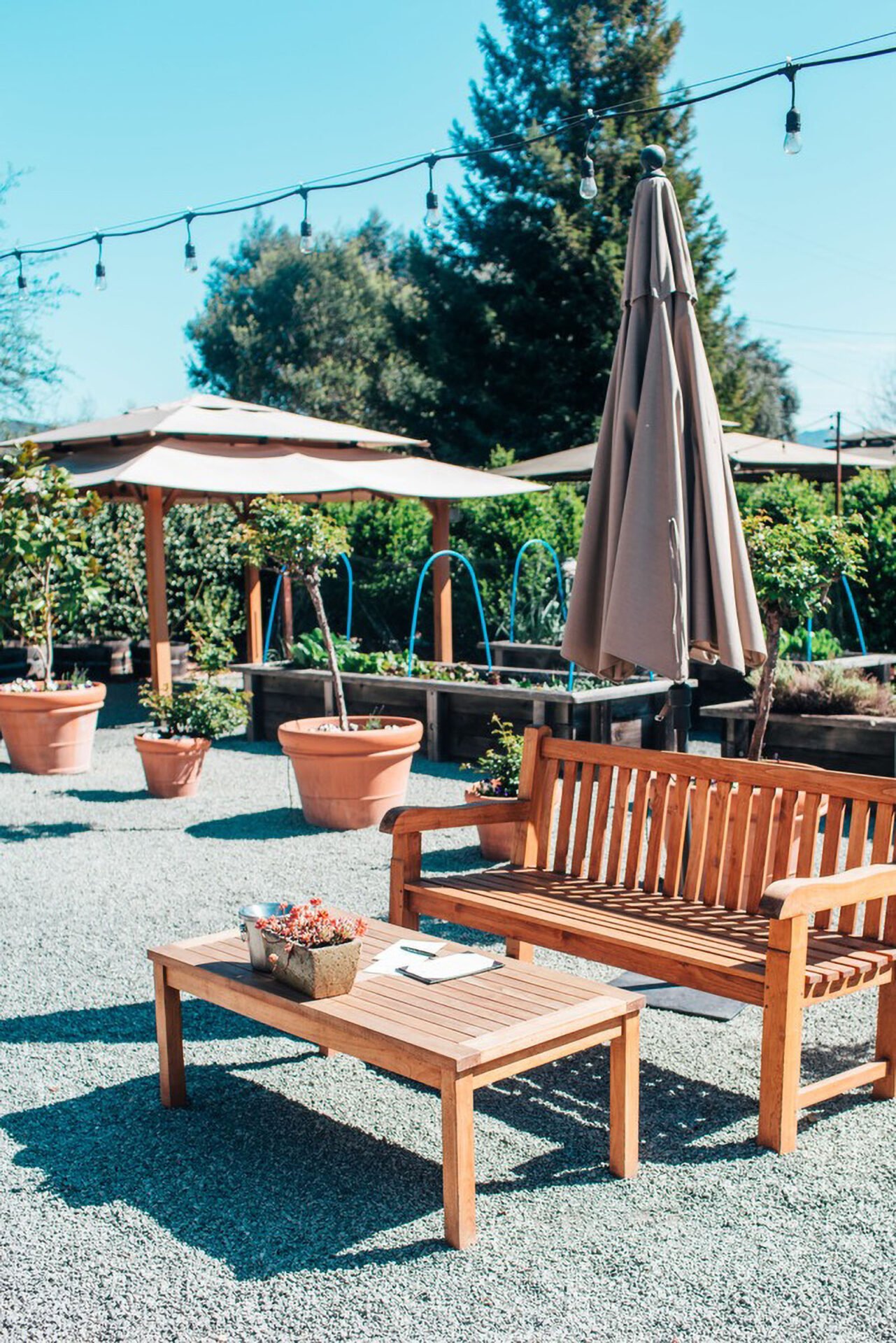 Outdoor garden seating with wooden bench and table.