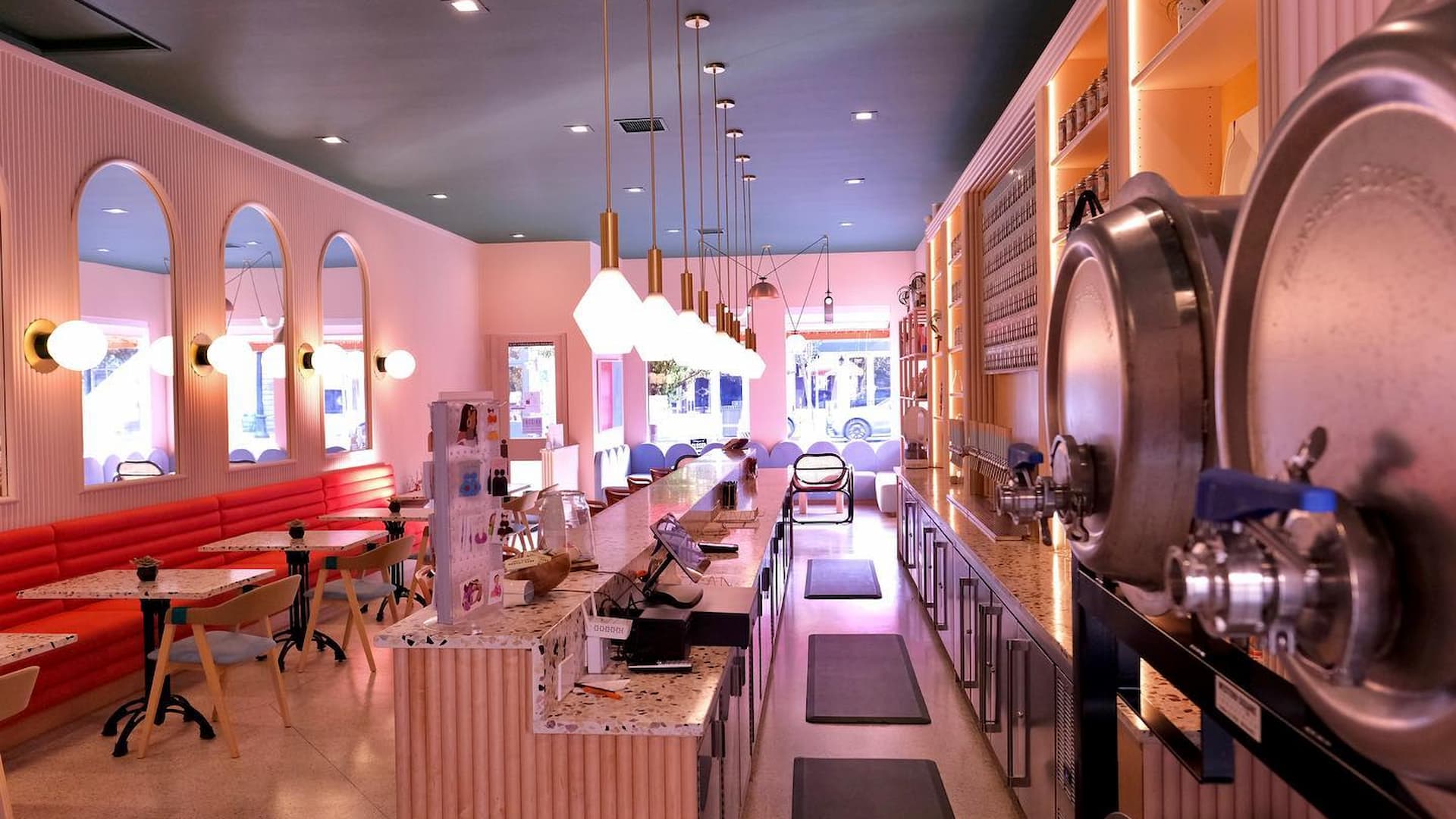 Modern pink cafe interior with bar and seating
