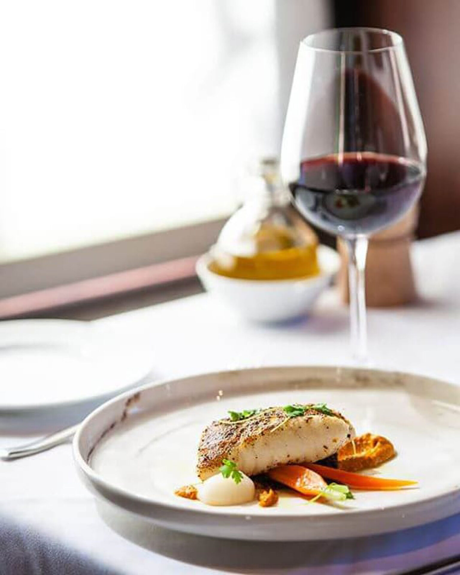 Grilled fish with vegetables and red wine.