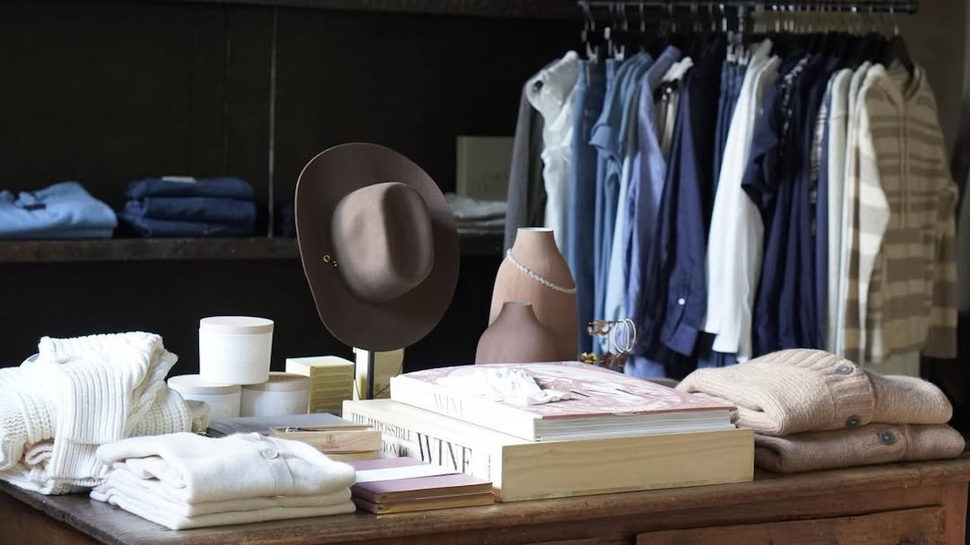 Boutique with clothes, hats, and accessories displayed.