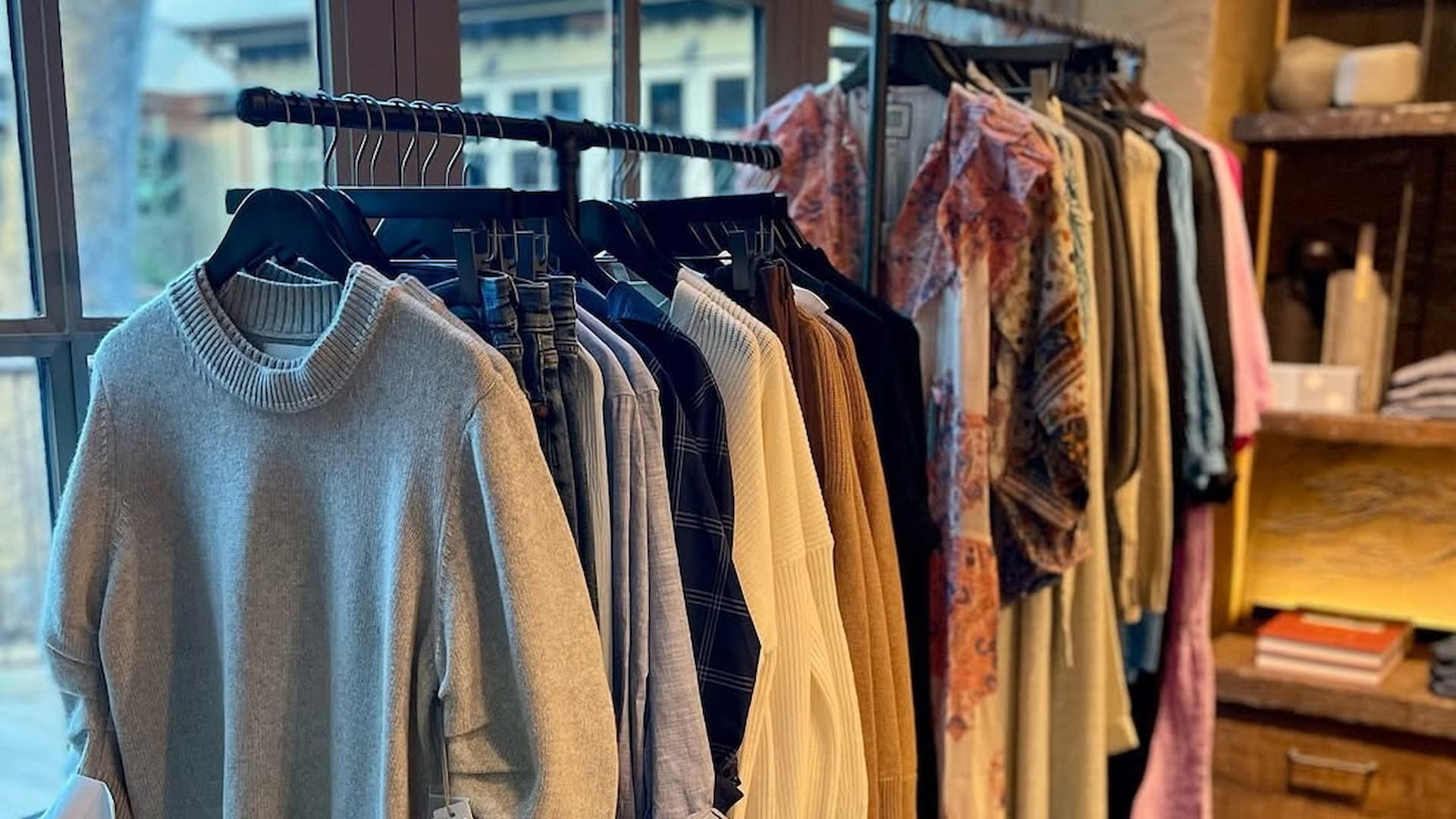 Clothes hanging on rack in boutique store display.