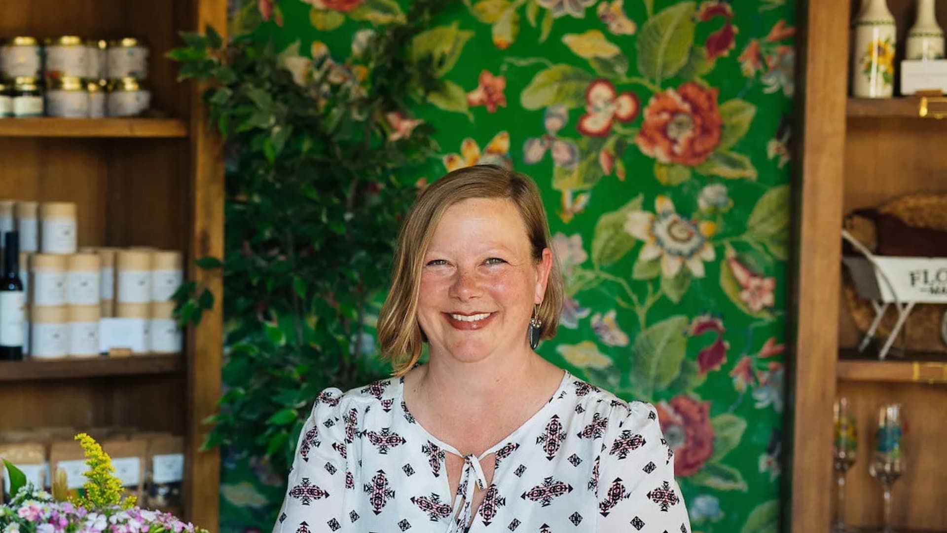Smiling woman in floral boutique setting