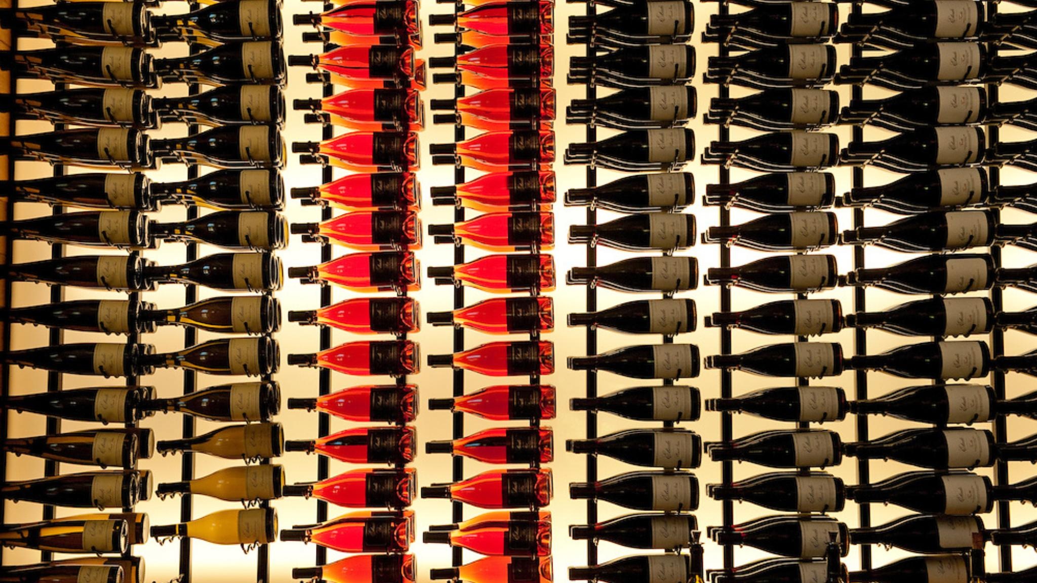 Colorful wine bottles displayed on shelves
