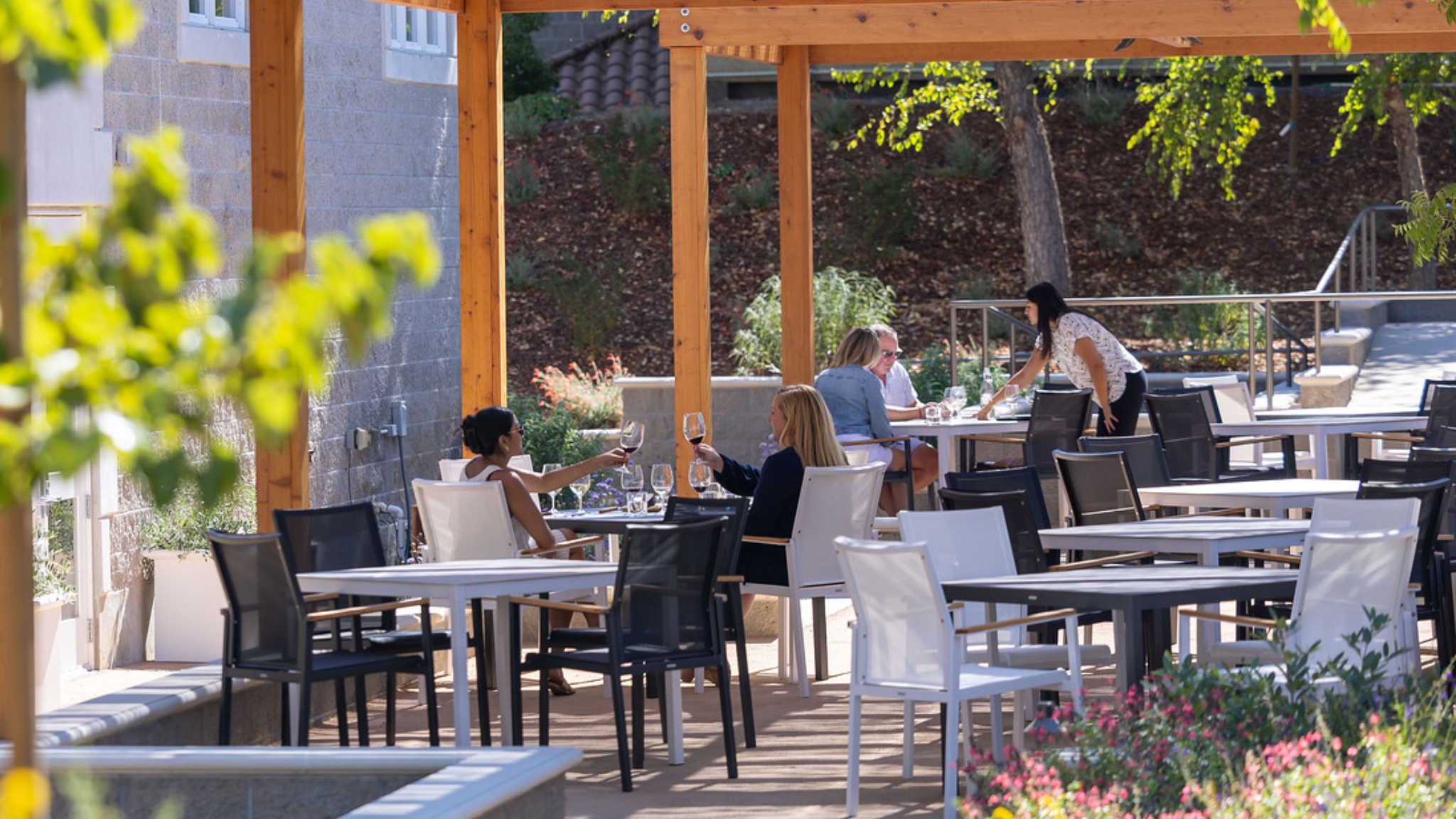 Outdoor patio dining scene with customers and server