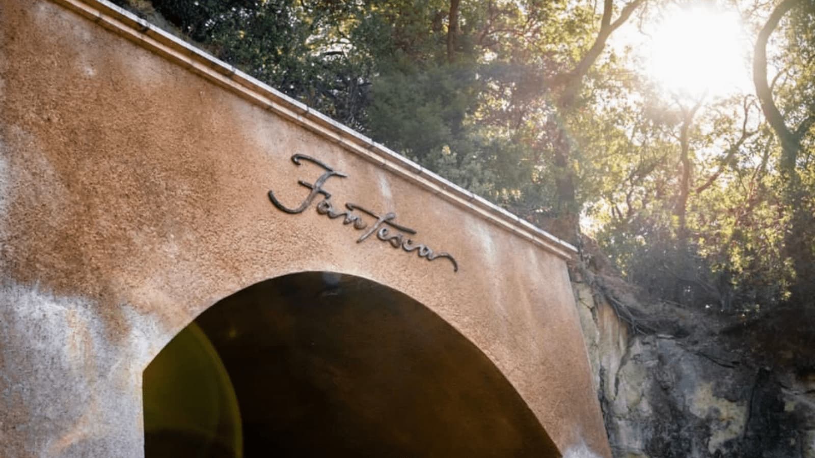 Fantasia sign on stucco archway in sunlight
