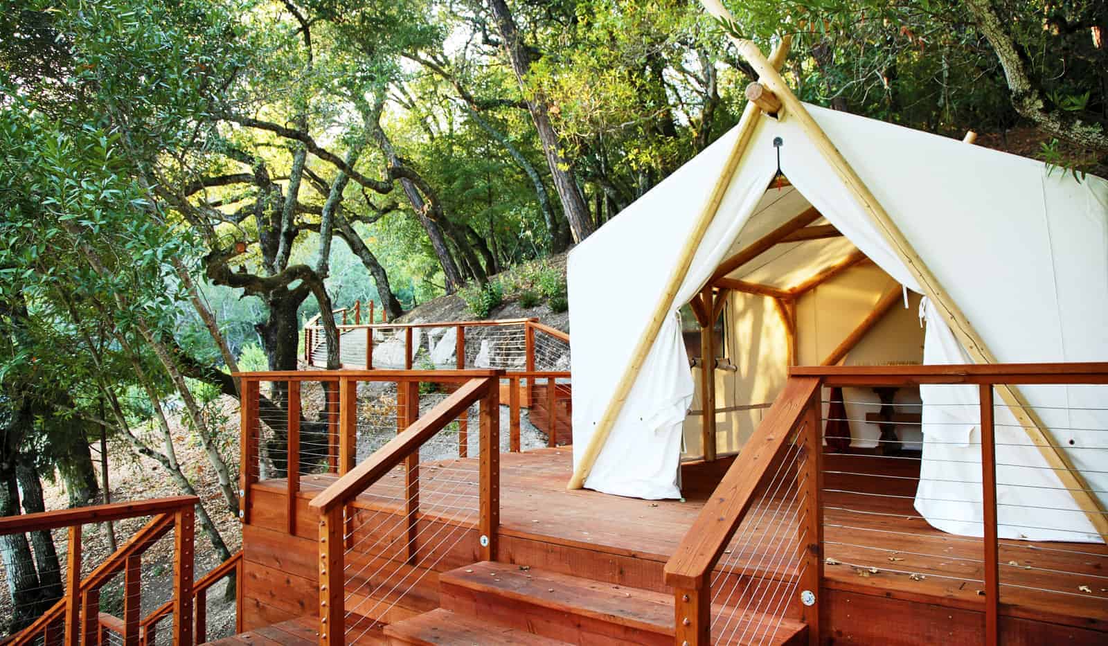 Luxury tent on wooden deck in forest