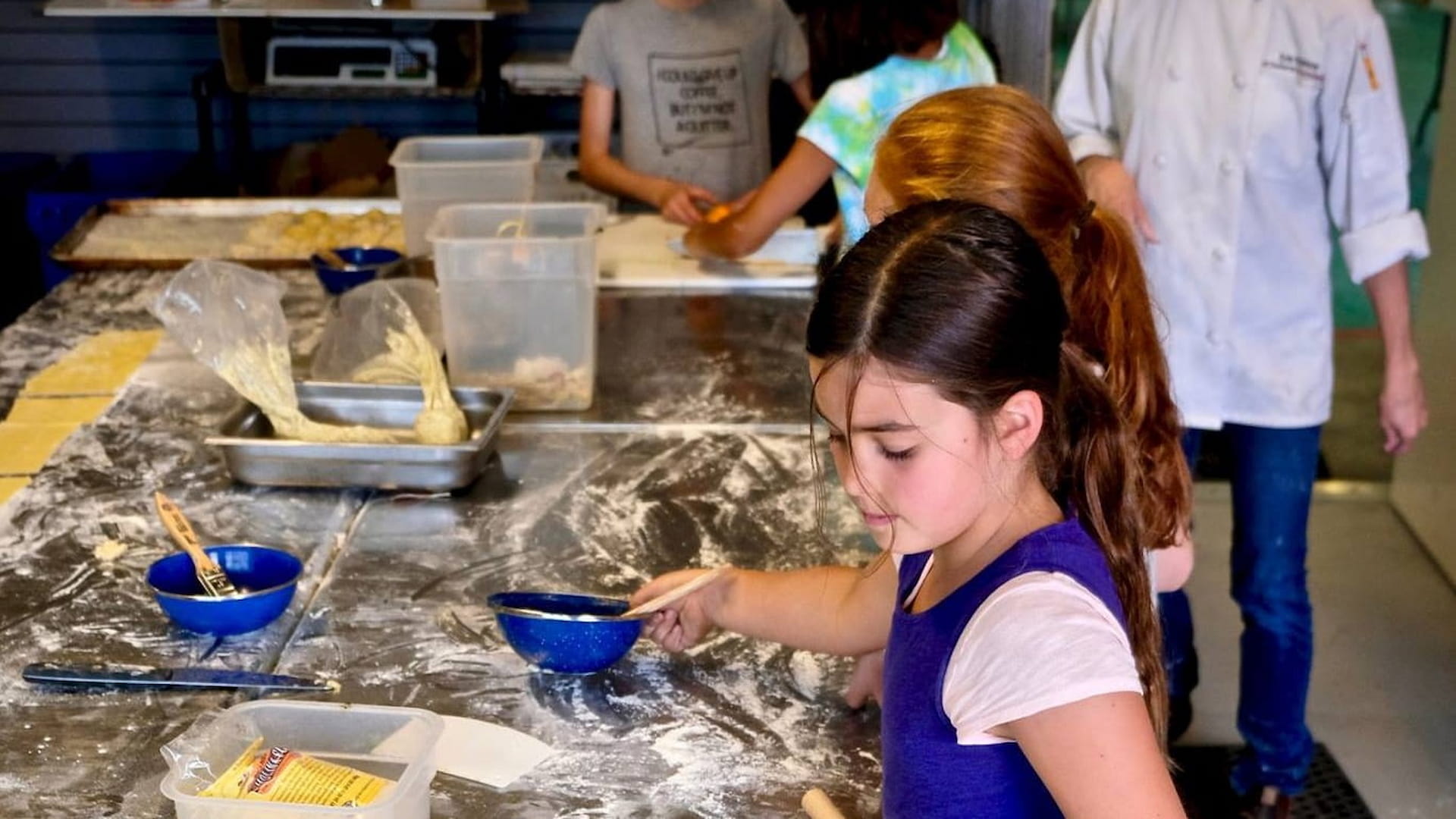 Children learning to cook in kitchen class