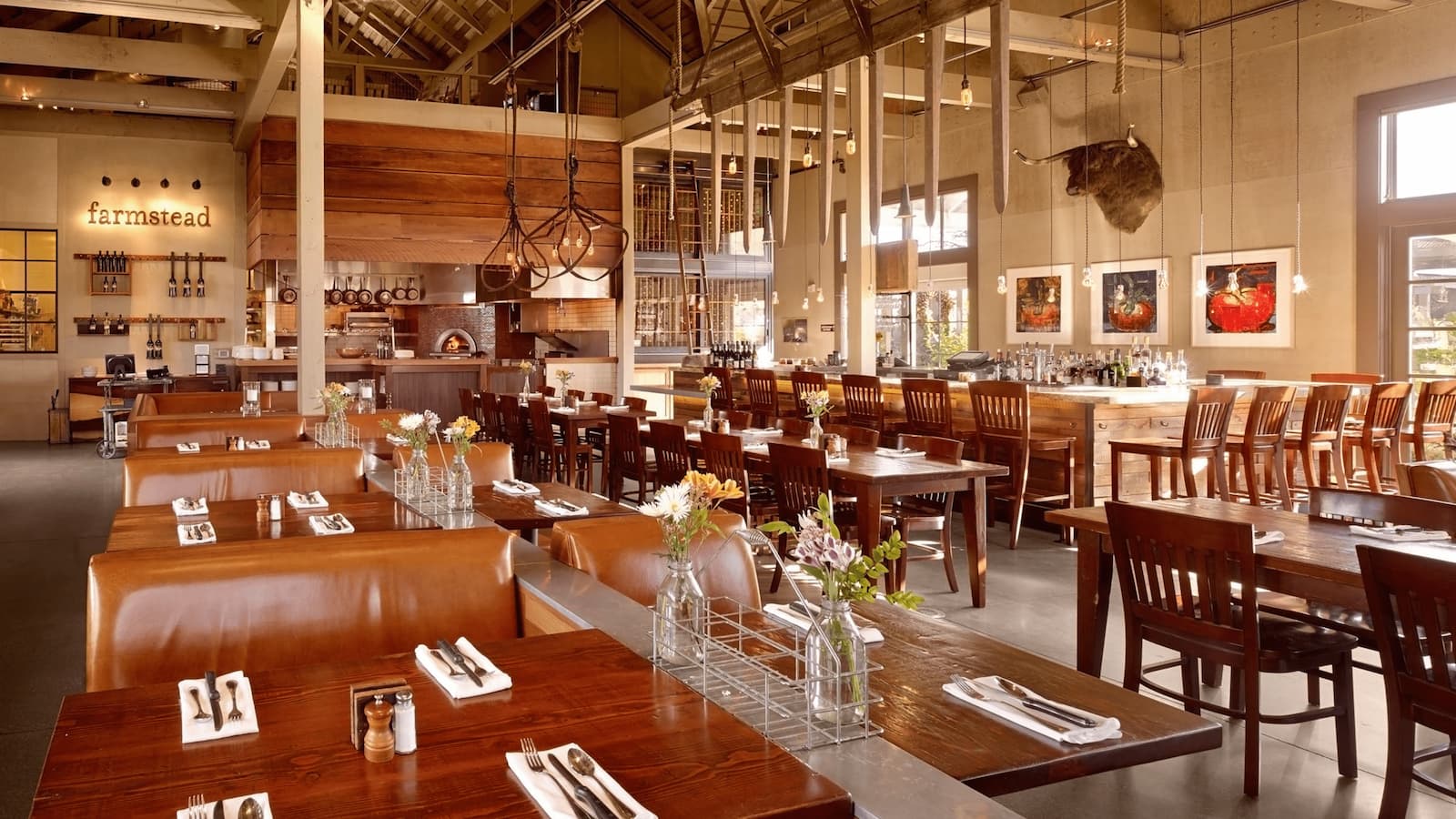 Cozy restaurant interior with wooden decor and tables.