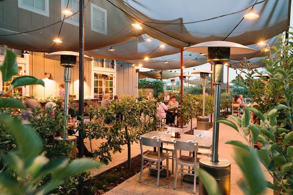Cozy outdoor restaurant patio with lights and heaters