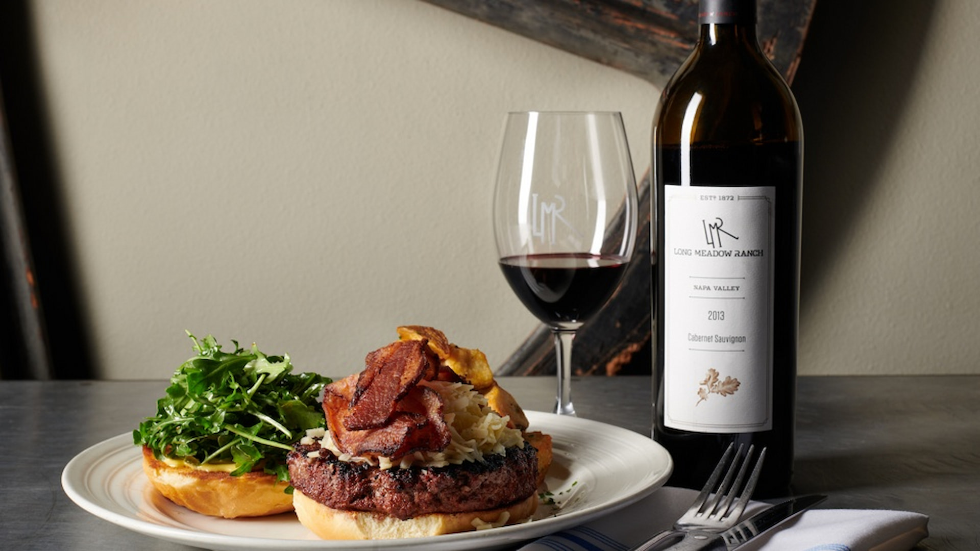 Gourmet burger with wine pairing on table