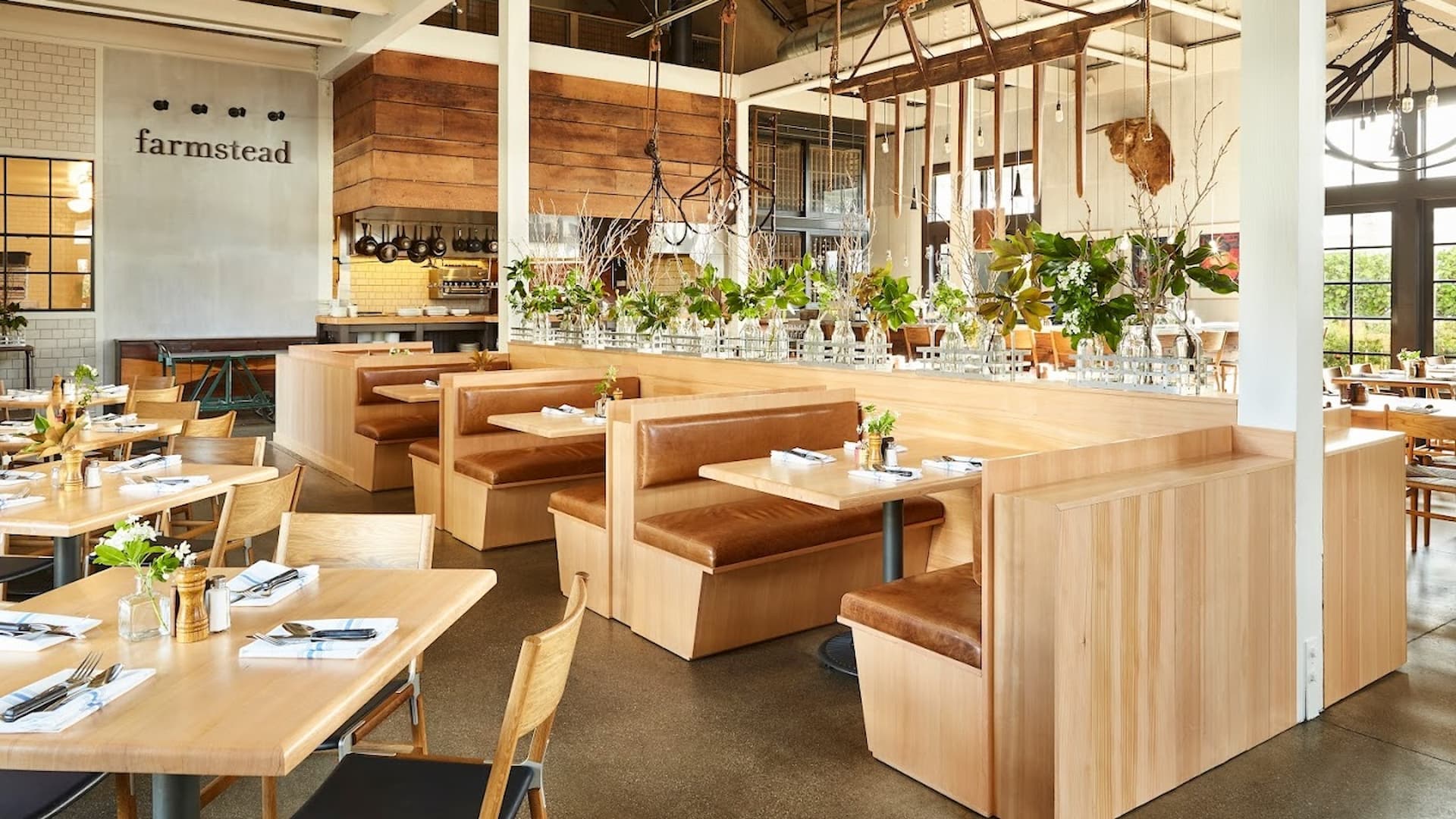 Rustic elegant restaurant interior with wooden tables, booths.