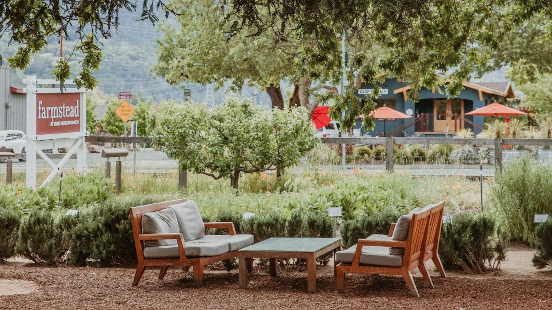 Outdoor seating at Farmstead with lush greenery.