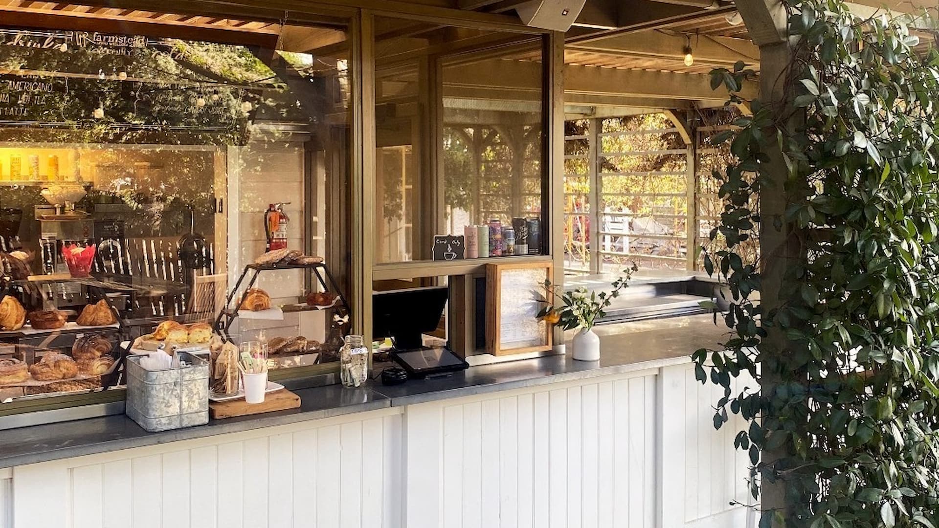 Outdoor bakery counter with pastries display.