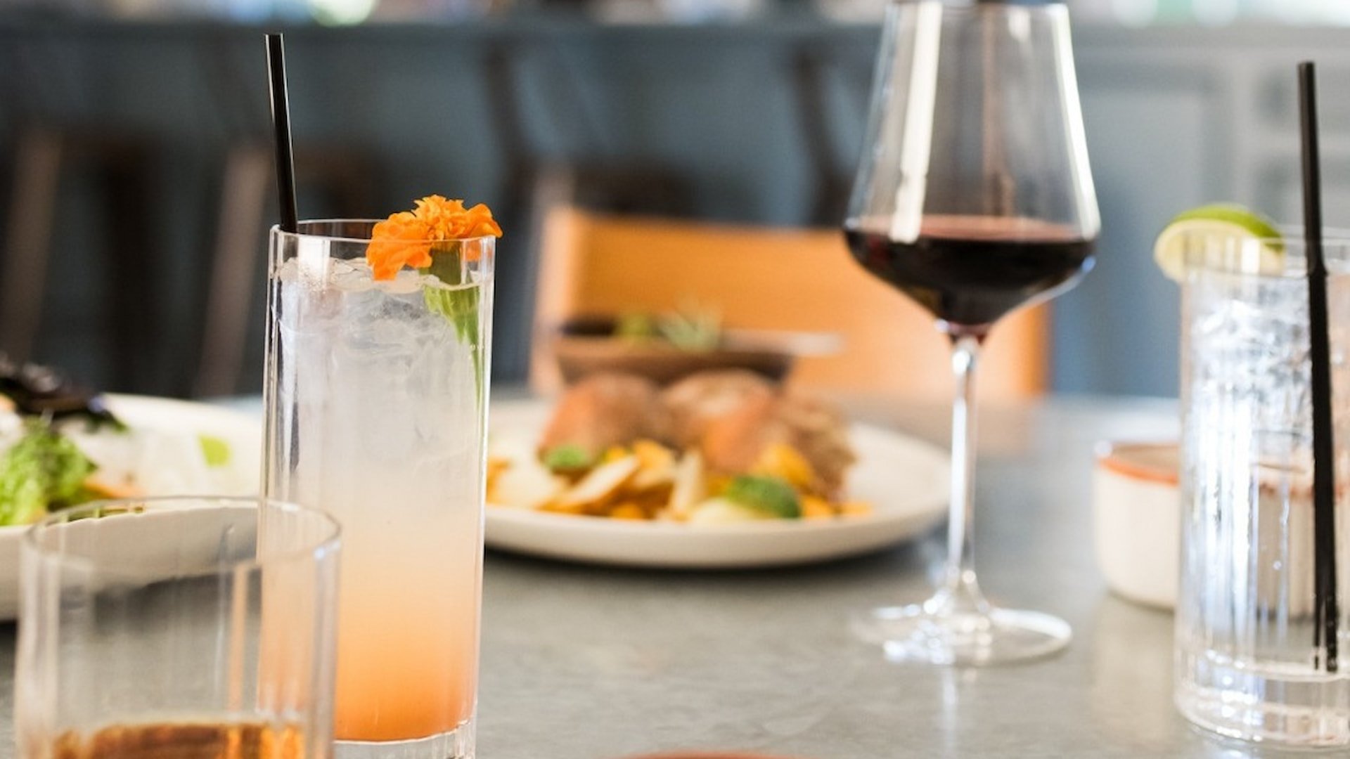 Cocktail and wine on table with food