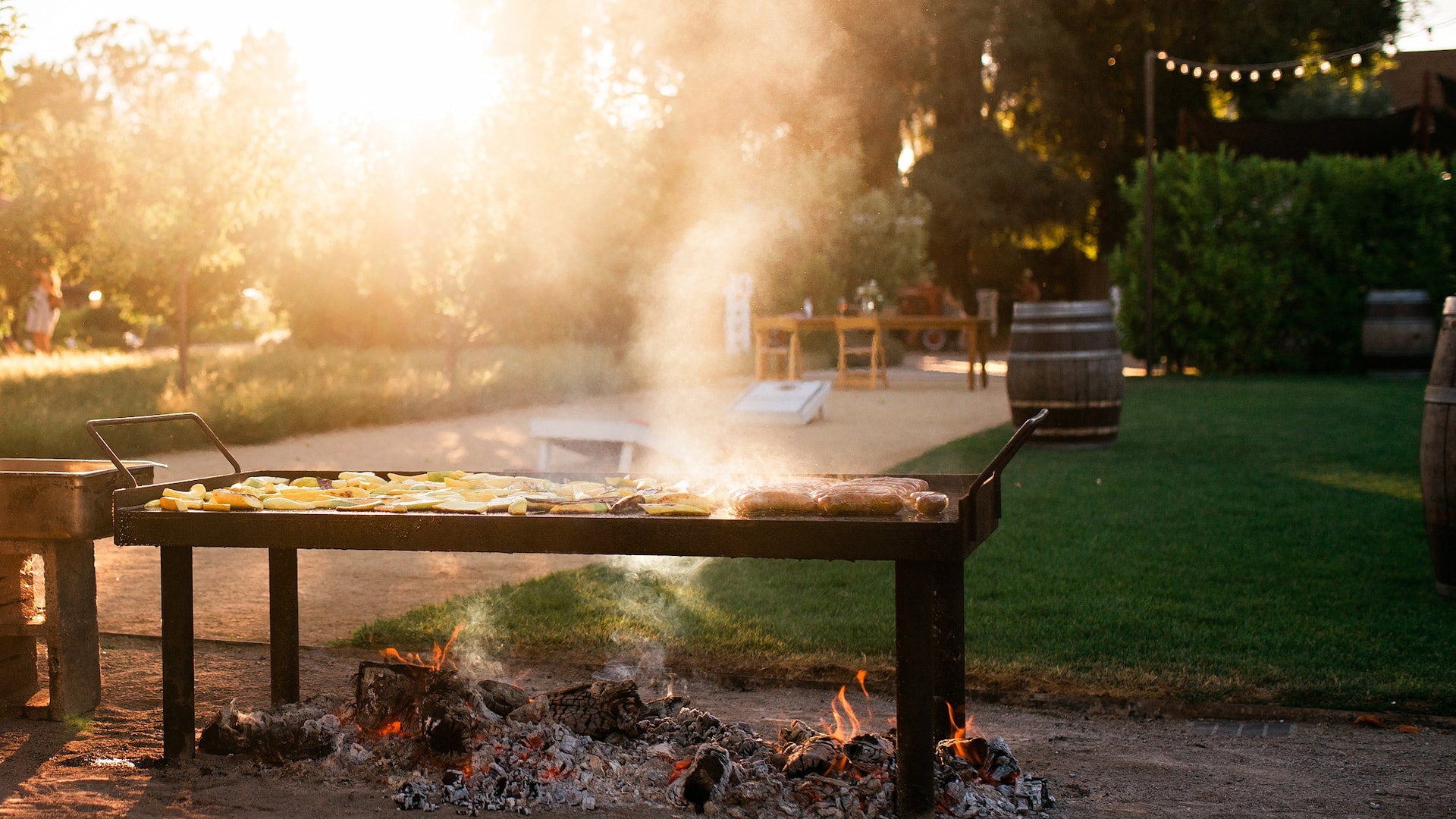 Outdoor grill with food on sunny day