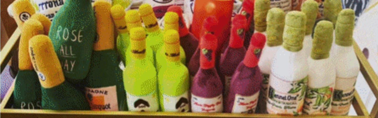 Colorful decorative towel wine bottles on tray