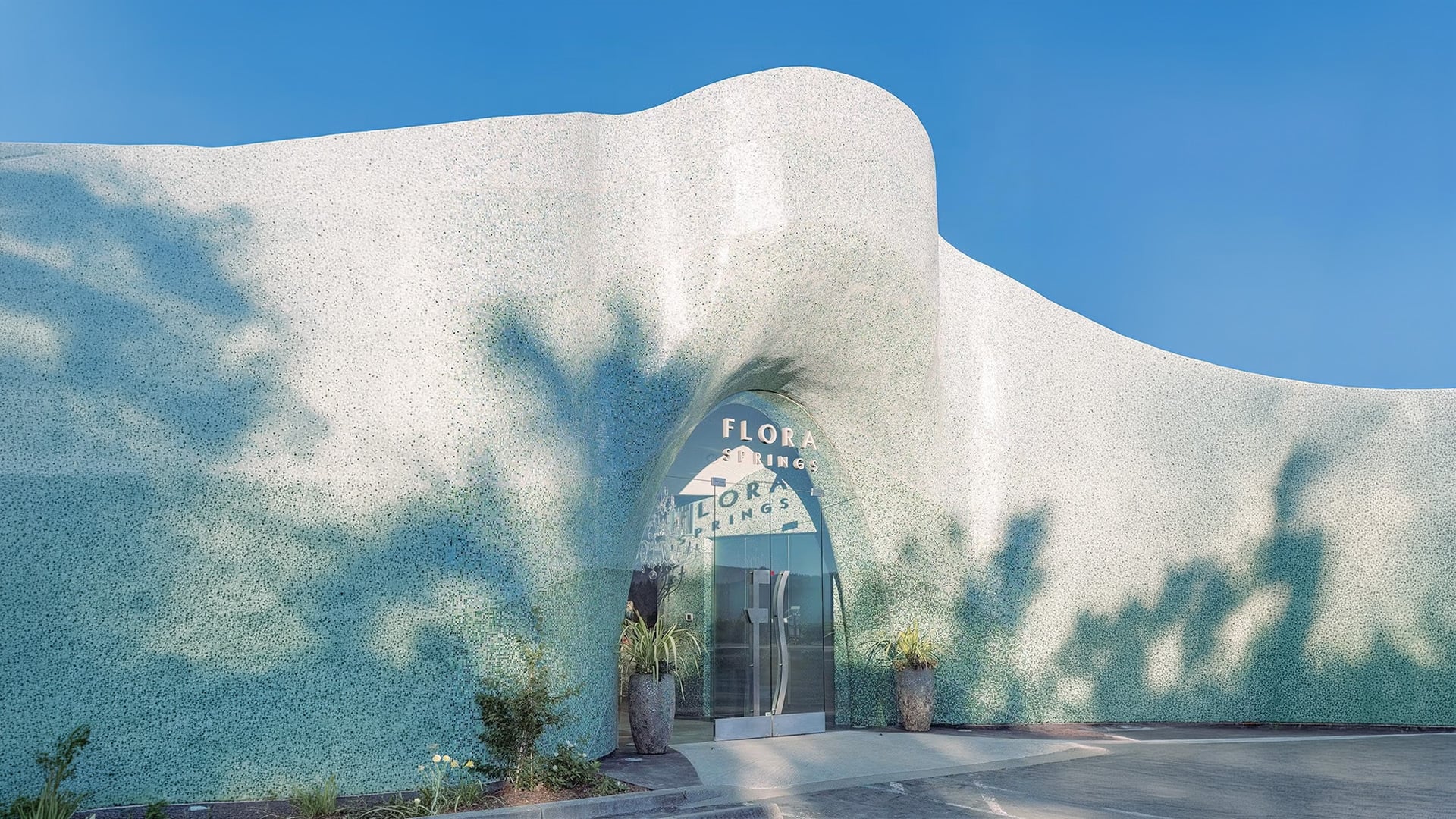 Flora Springs entrance with curved green mosaic facade