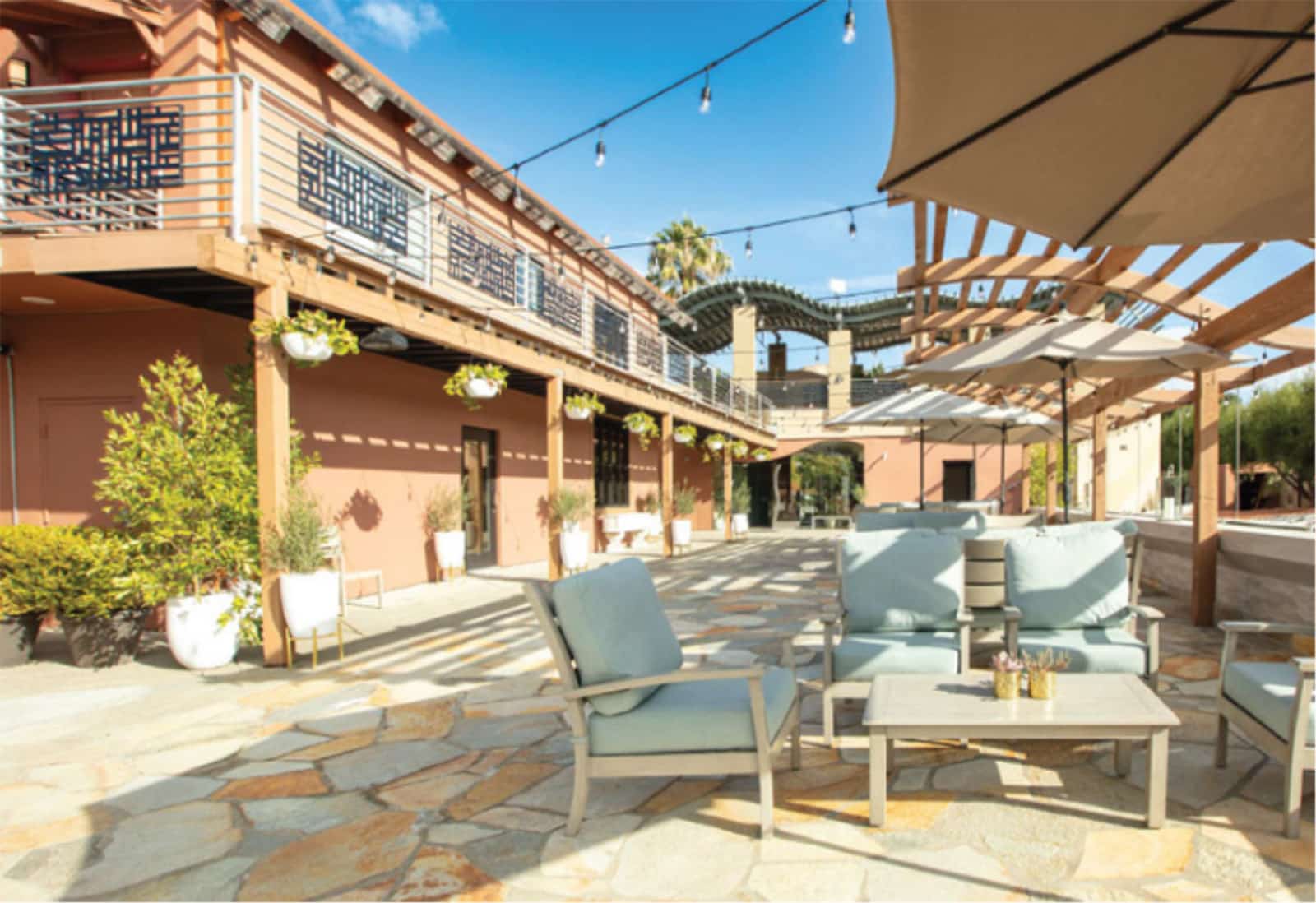 Outdoor patio with seating and umbrellas.