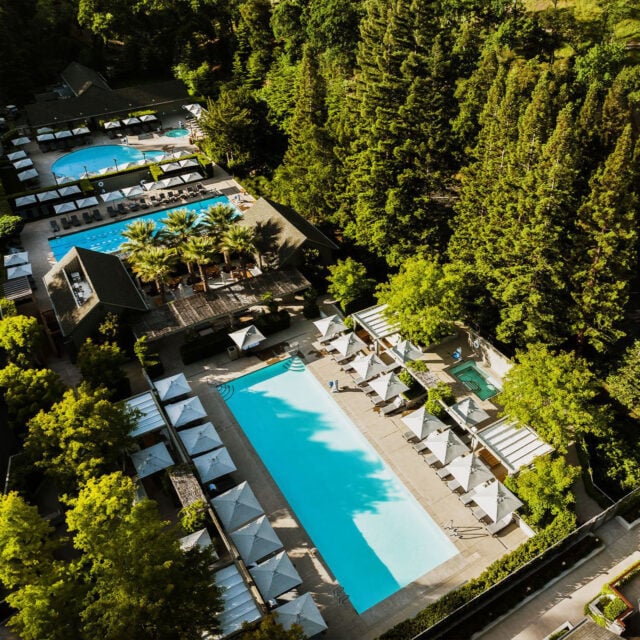 Aerial view of resort with pools and greenery