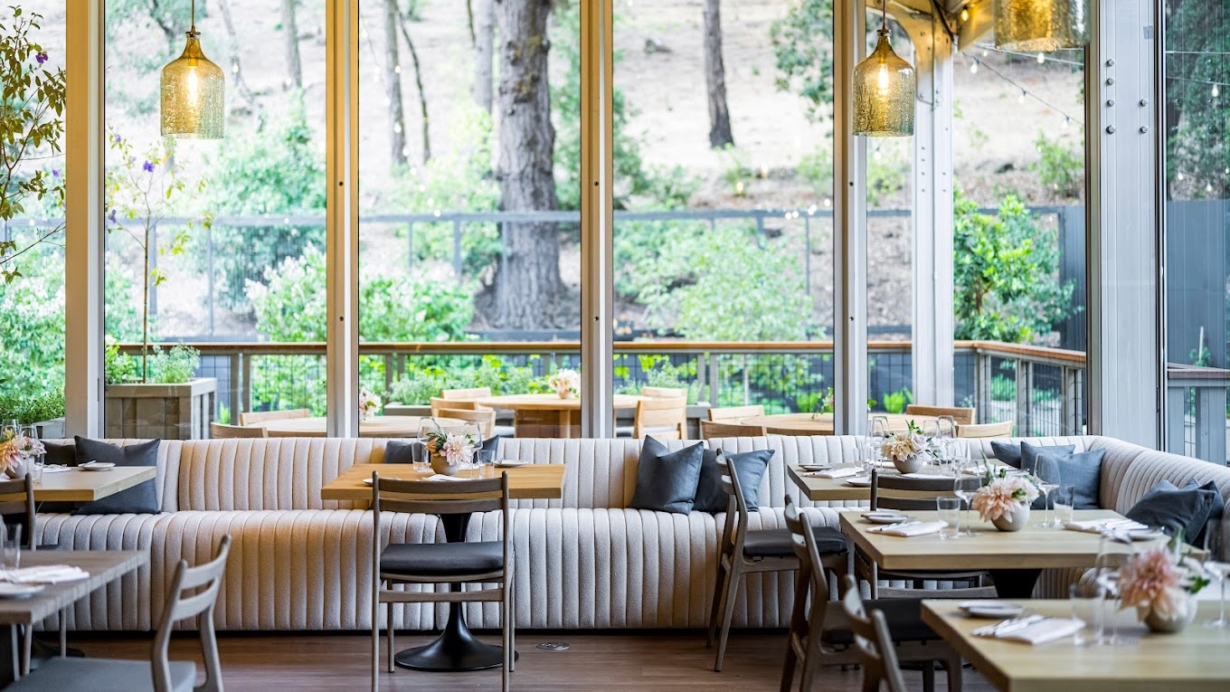 Cozy restaurant interior with large windows and seating.