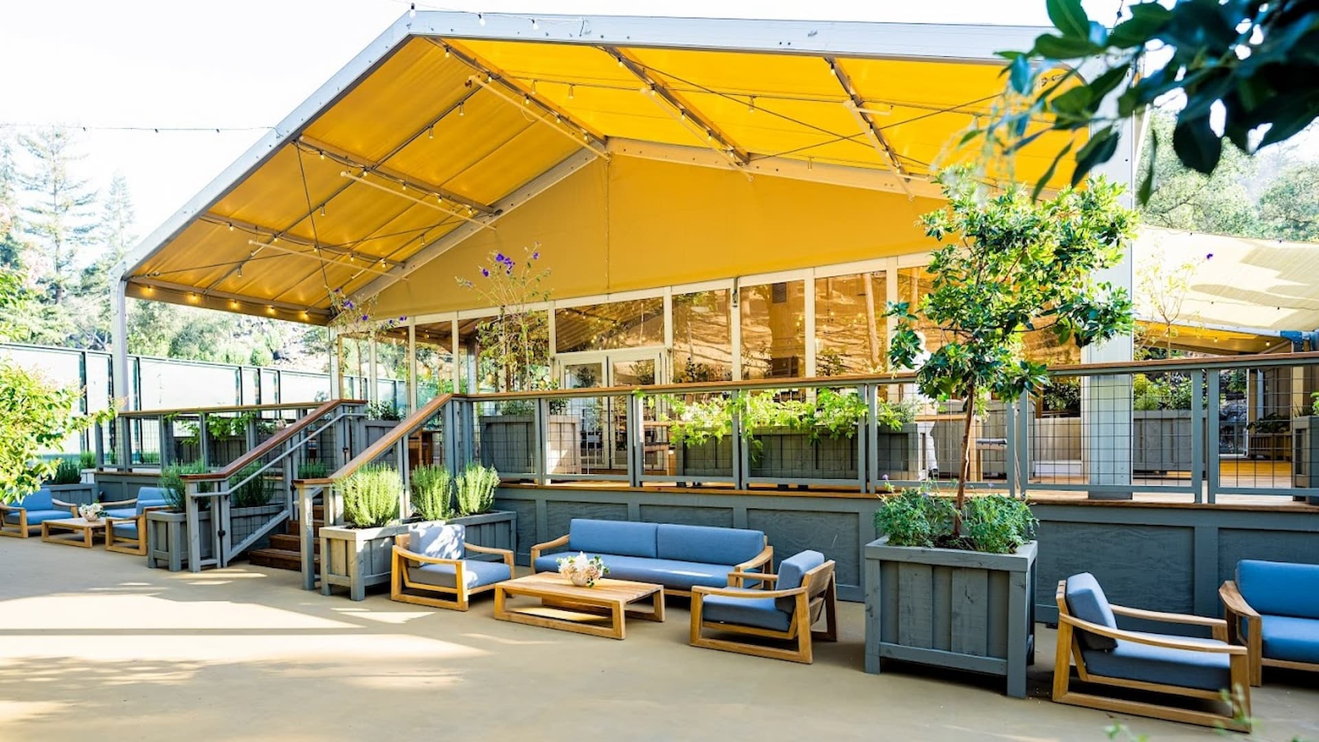 Outdoor patio with seating and yellow canopy