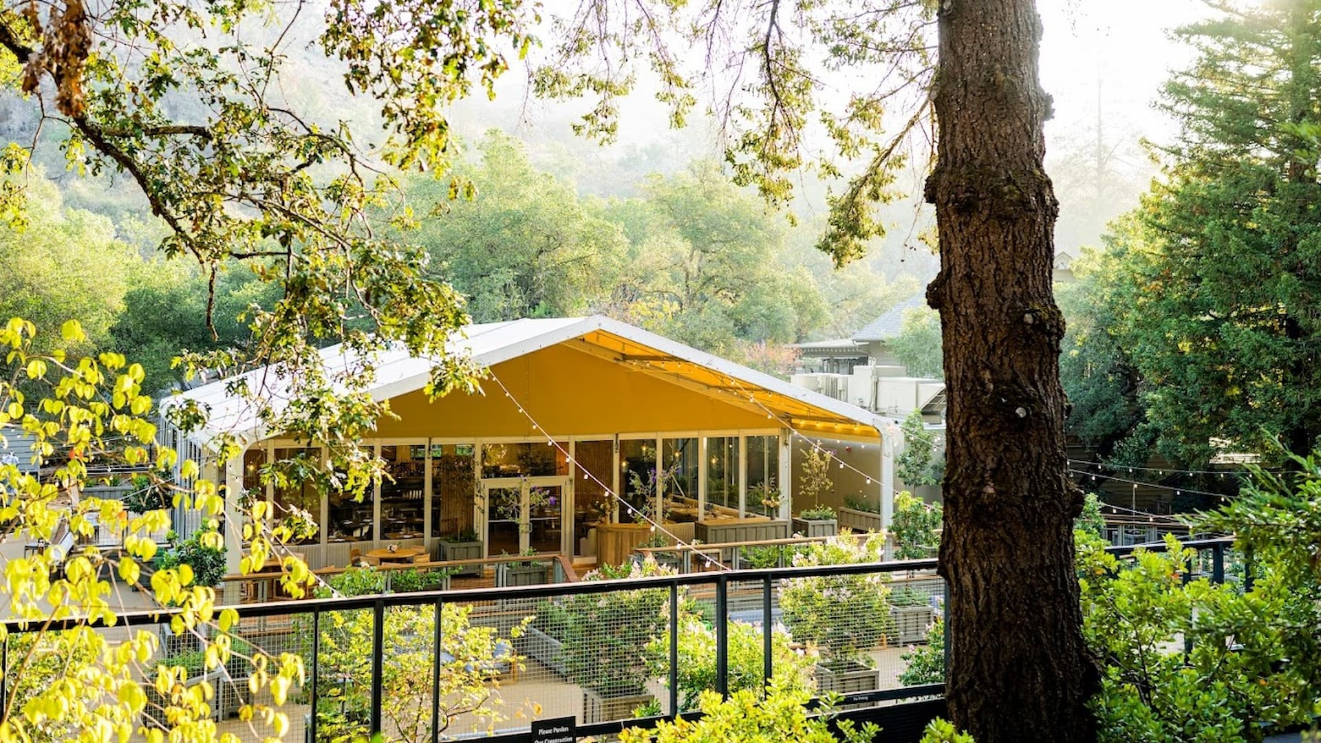 Outdoor pavilion surrounded by lush greenery.