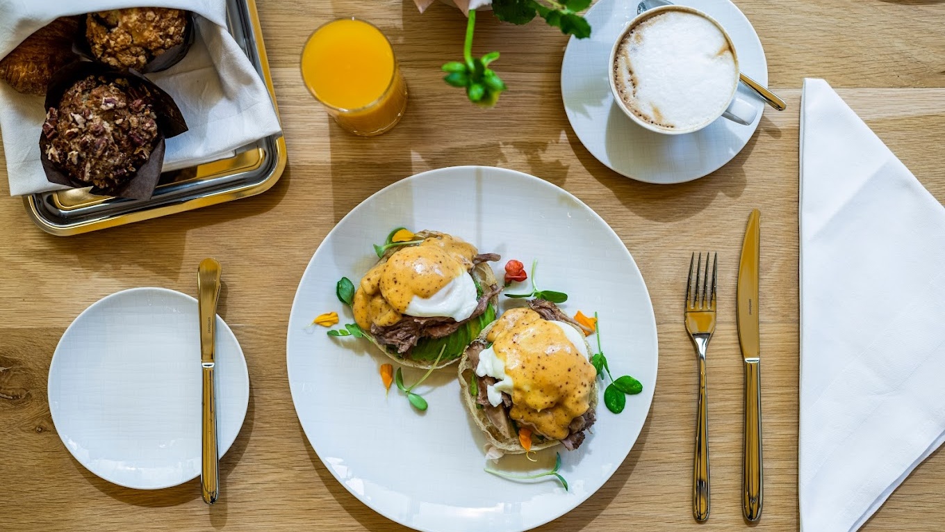 Brunch plate with eggs benedict and coffee