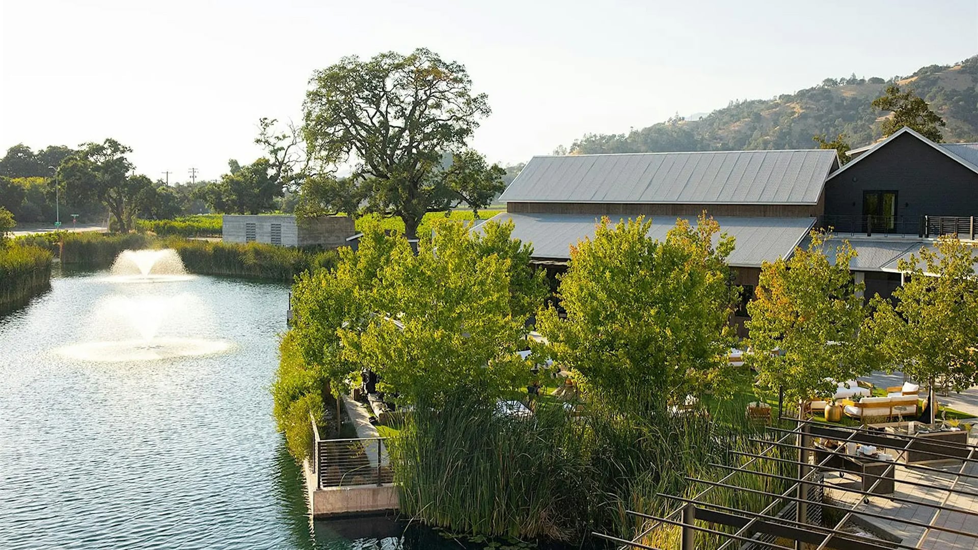 Lakeside modern building with patio and fountain
