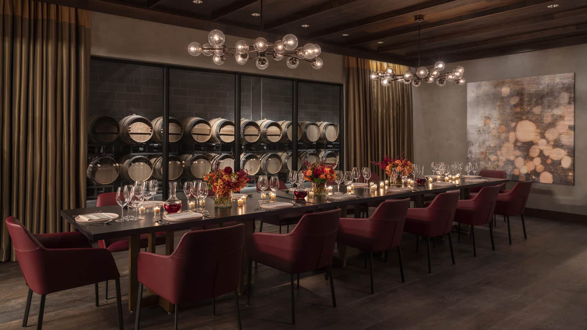 Elegant dining room with wine barrels and candles.