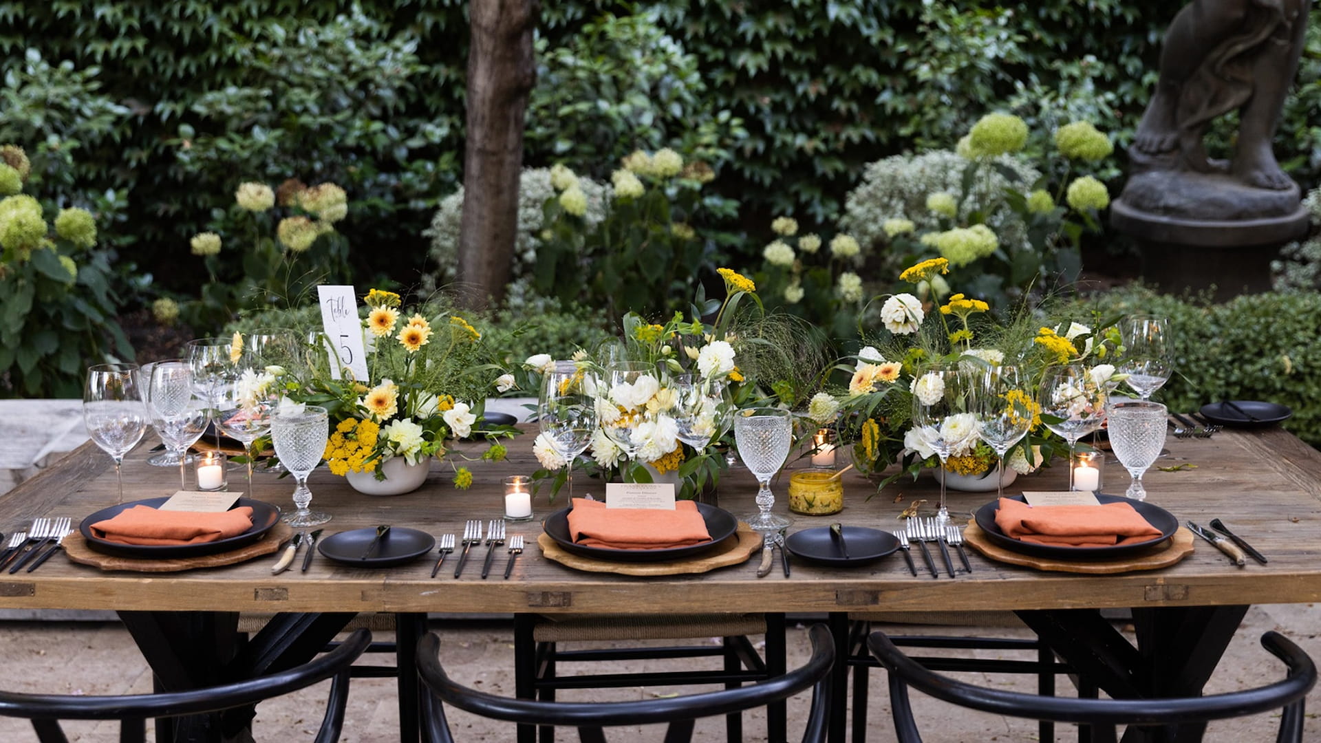 Elegant outdoor table setup with flowers and candles