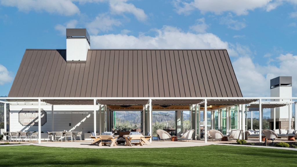 Modern farmhouse venue with patio and blue sky.