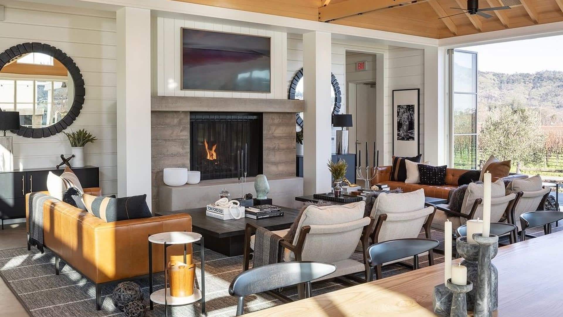 Modern living room with fireplace and large windows.