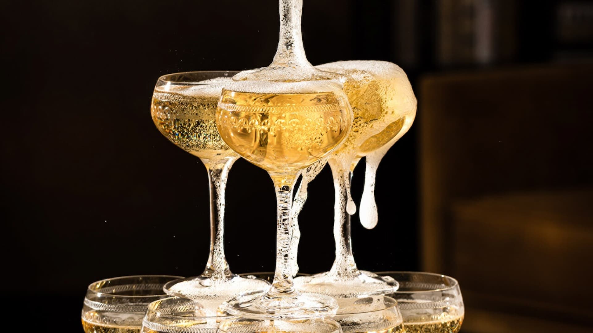 Champagne cascading into elegant coupe glasses