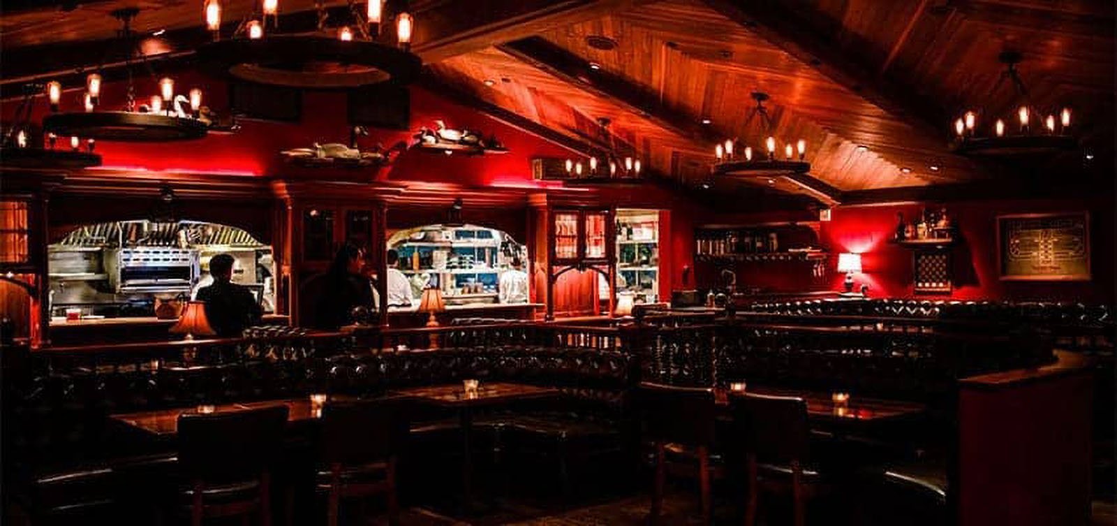 Cozy restaurant with dim lighting and wooden decor.