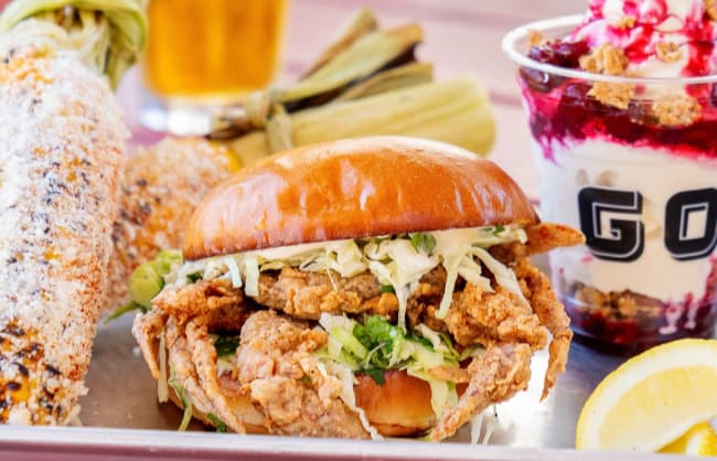Fried chicken sandwich with corn and parfait