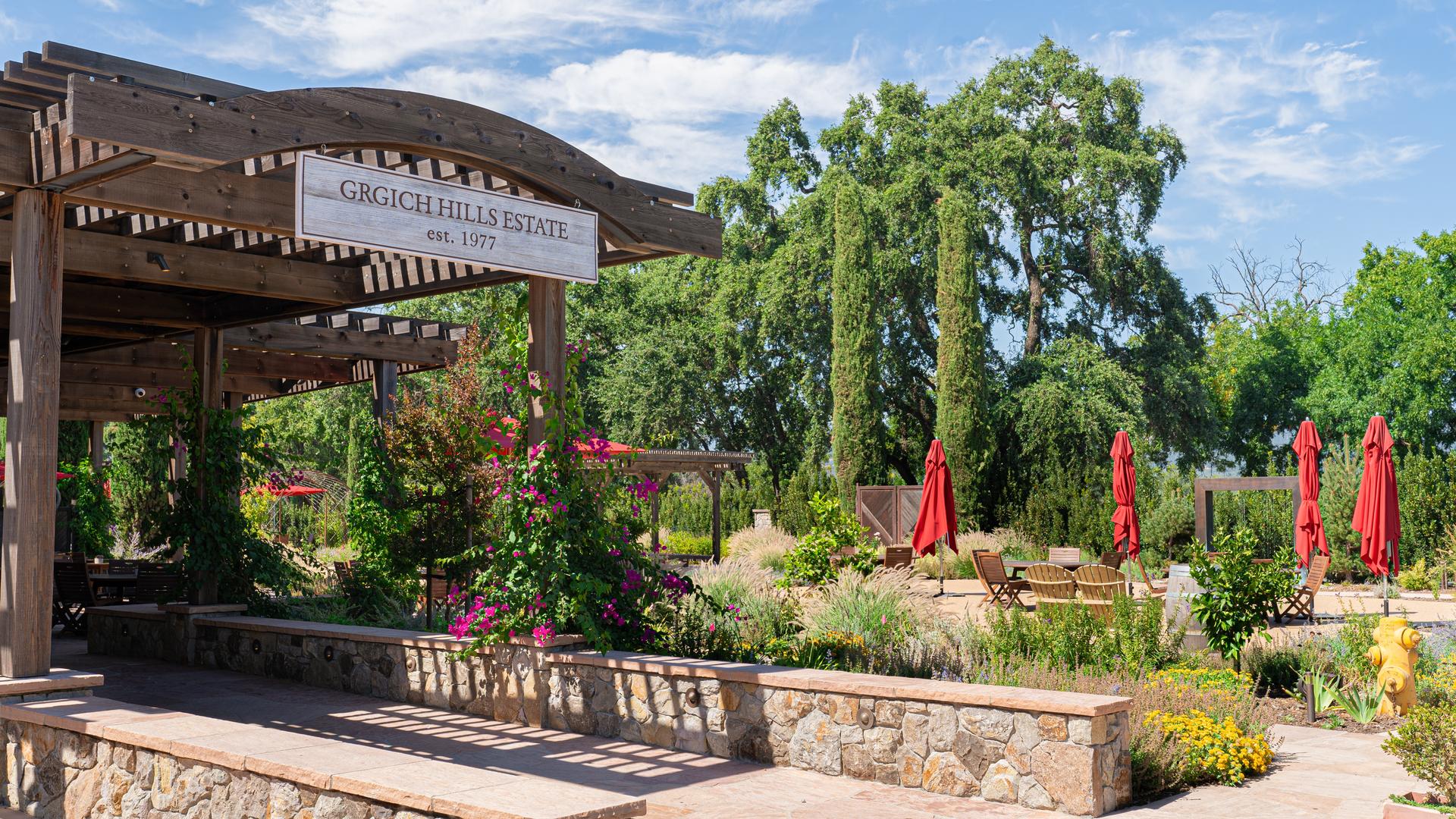 Grgich Hills Estate outdoor seating area with greenery.